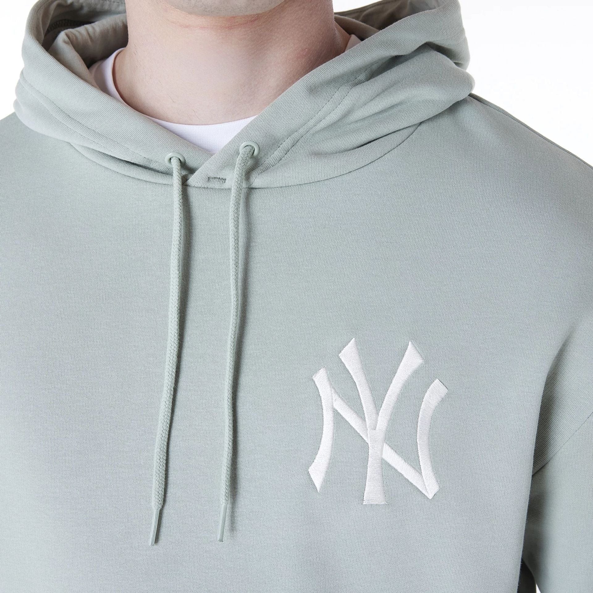 The Male model is wearing New York Yankees MLB League Essential Pastel Green Oversized Pullover Hoodie 4