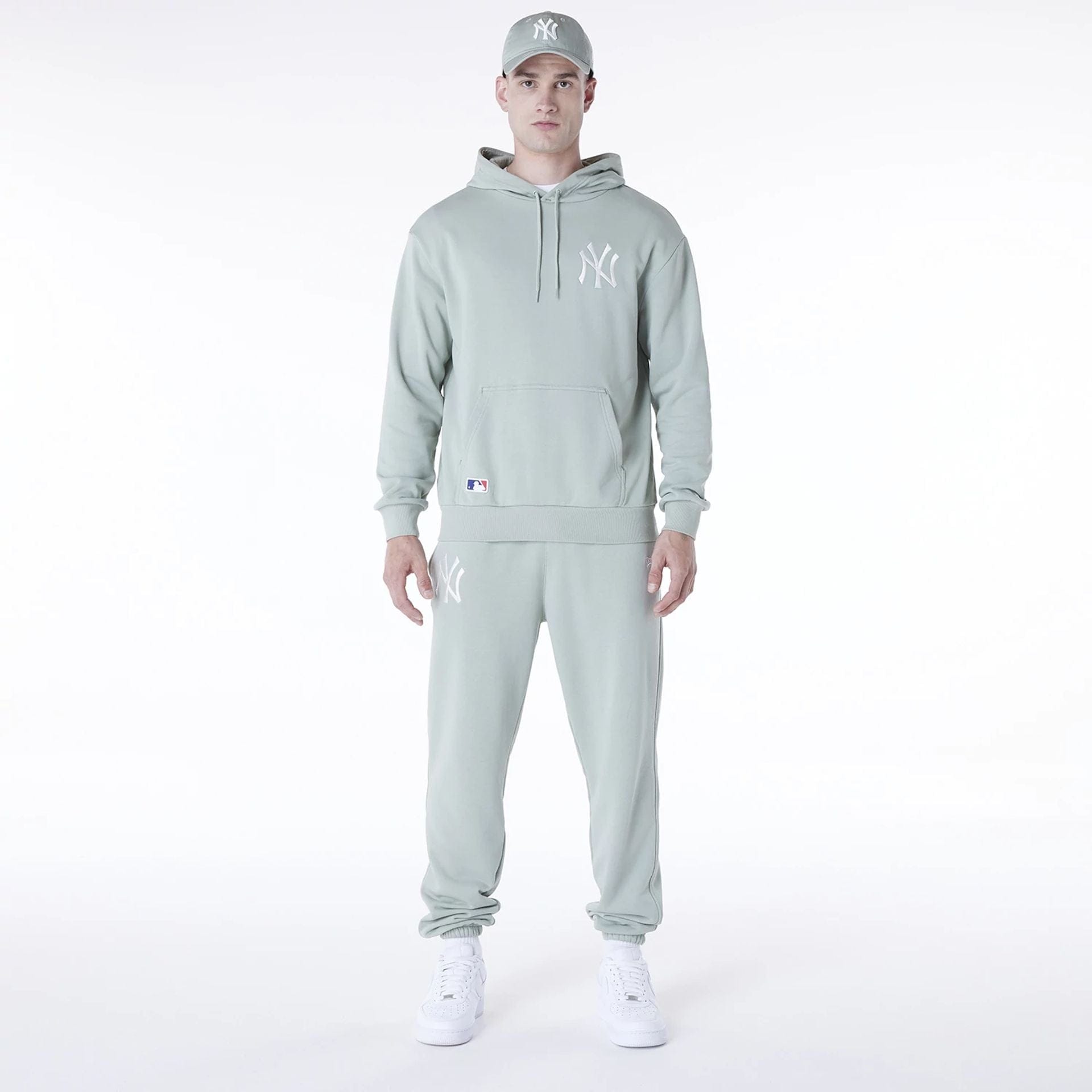 The Male model is wearing New York Yankees MLB League Essential Pastel Green Oversized Pullover Hoodie 3