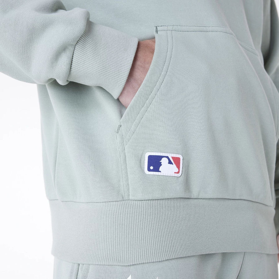 The Male model is wearing New York Yankees MLB League Essential Pastel Green Oversized Pullover Hoodie 6