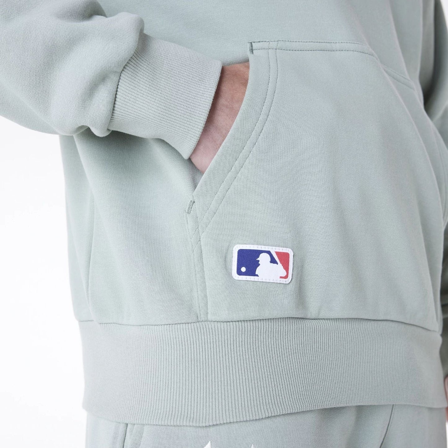 The Male model is wearing New York Yankees MLB League Essential Pastel Green Oversized Pullover Hoodie 6