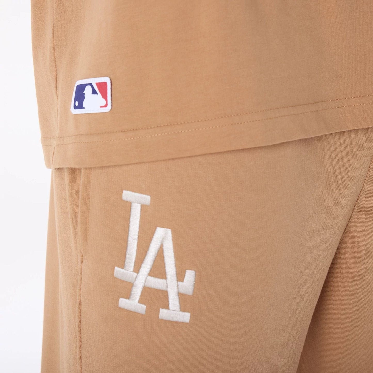 The Male model is wearing LA Dodgers MLB League Essential Dark Beige Fleece Joggers 3