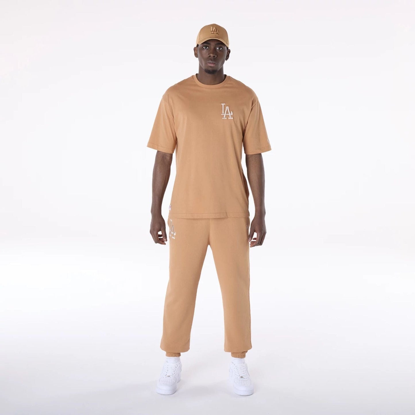 The Male model is wearing LA Dodgers MLB League Essential Dark Beige Fleece Joggers 8