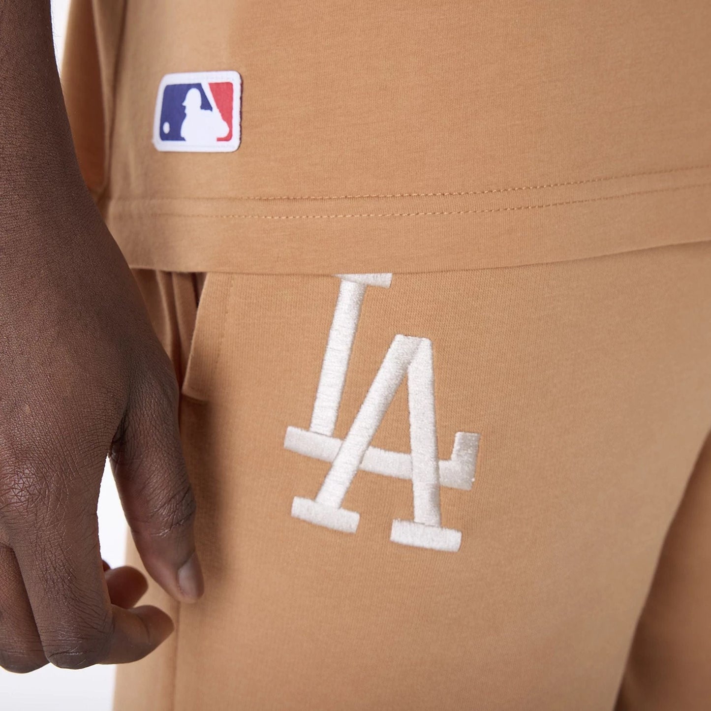 The Male model is wearing LA Dodgers MLB League Essential Dark Beige Shorts 4