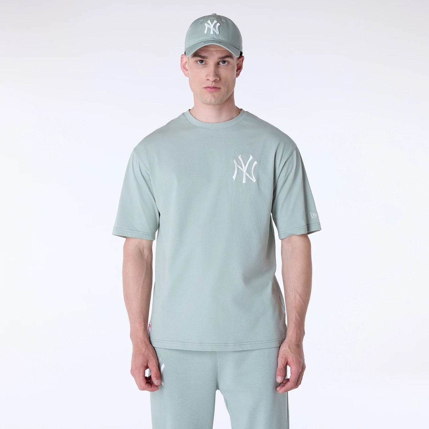 The Male model is wearing New York Yankees MLB League Essential Pastel Green Top And Shorts Set 3