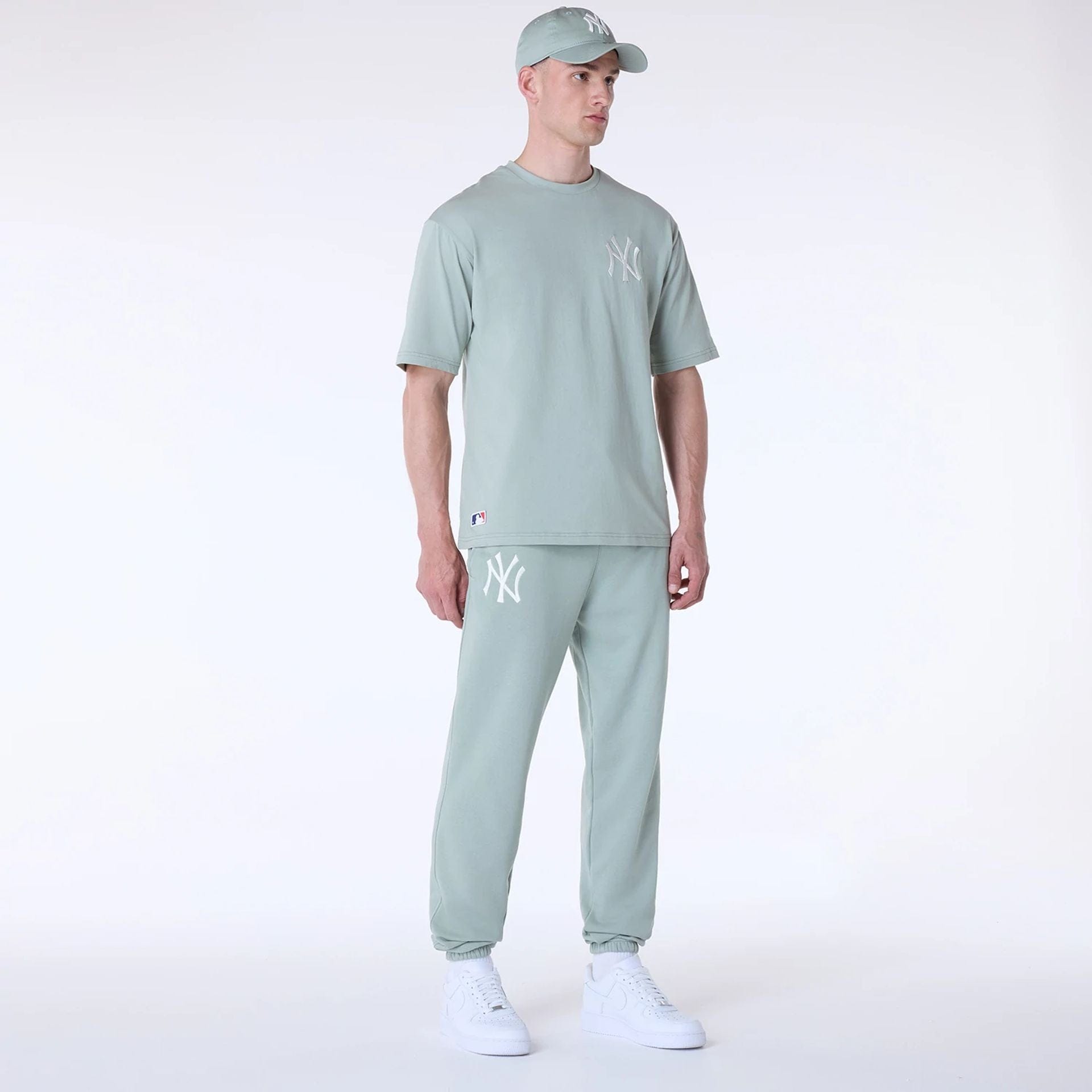 The Male model is wearing New York Yankees MLB League Essential Pastel Green Fleece Joggers 8