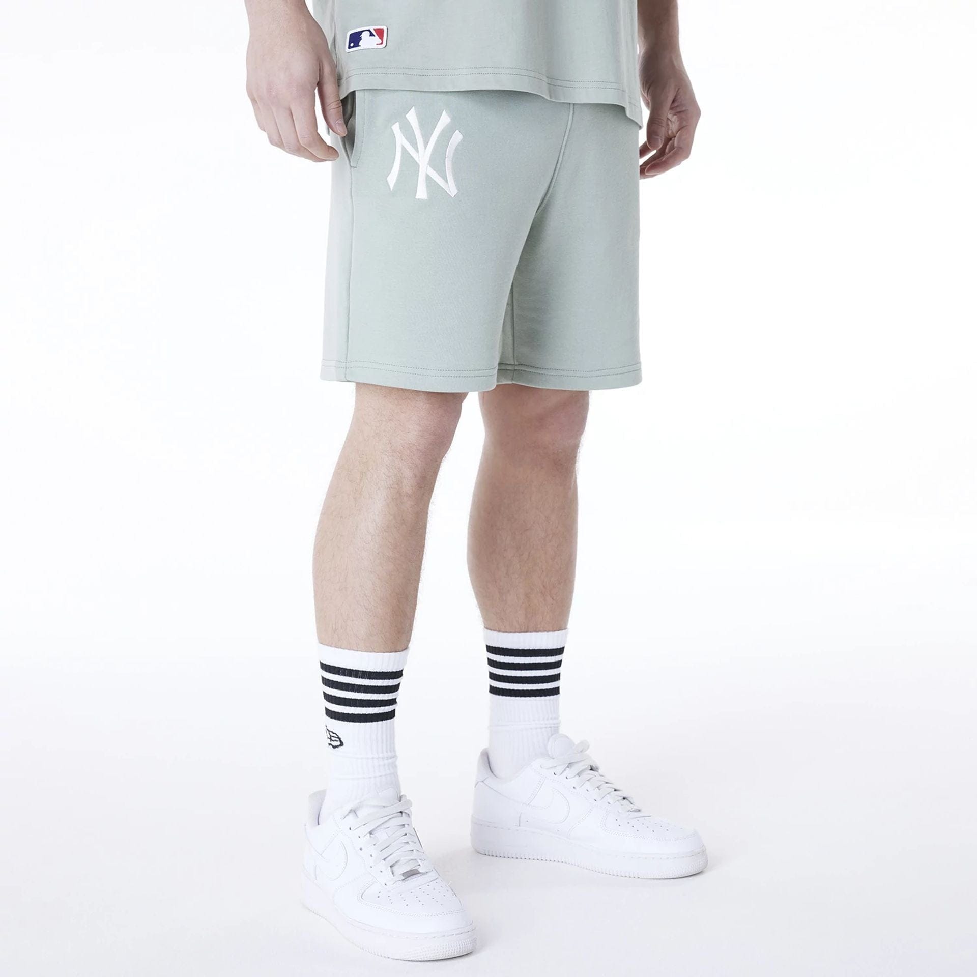 The Male model is wearing New York Yankees MLB League Essential Pastel Green Top And Shorts Set 4