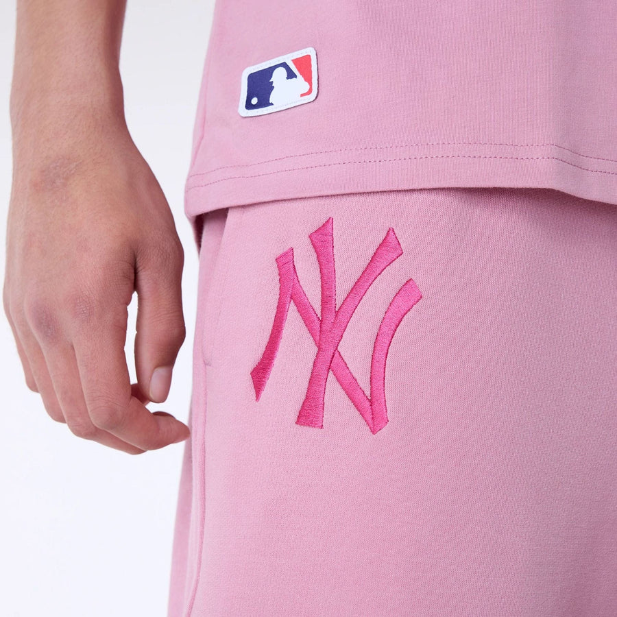 The Male model is wearing New York Yankees MLB League Essential Dark Pink Fleece Joggers 6