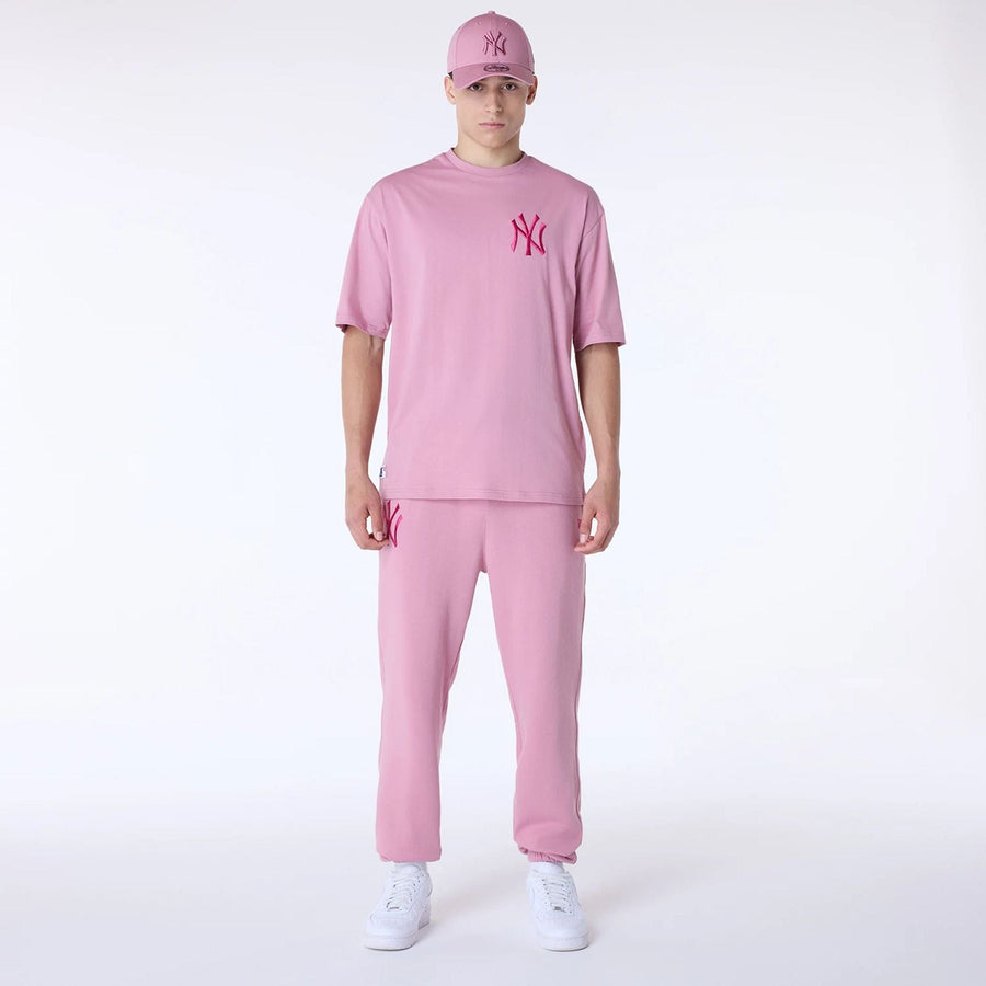 The Male model is wearing New York Yankees MLB League Essential Dark Pink Fleece Joggers 8