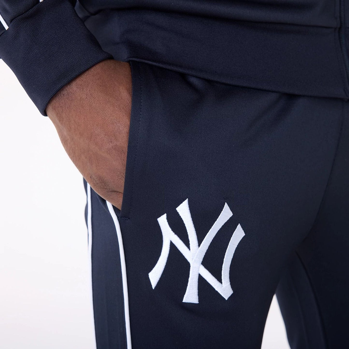 The Male model is wearing New York Yankees MLB Track Pants Navy Fleece Joggers 7