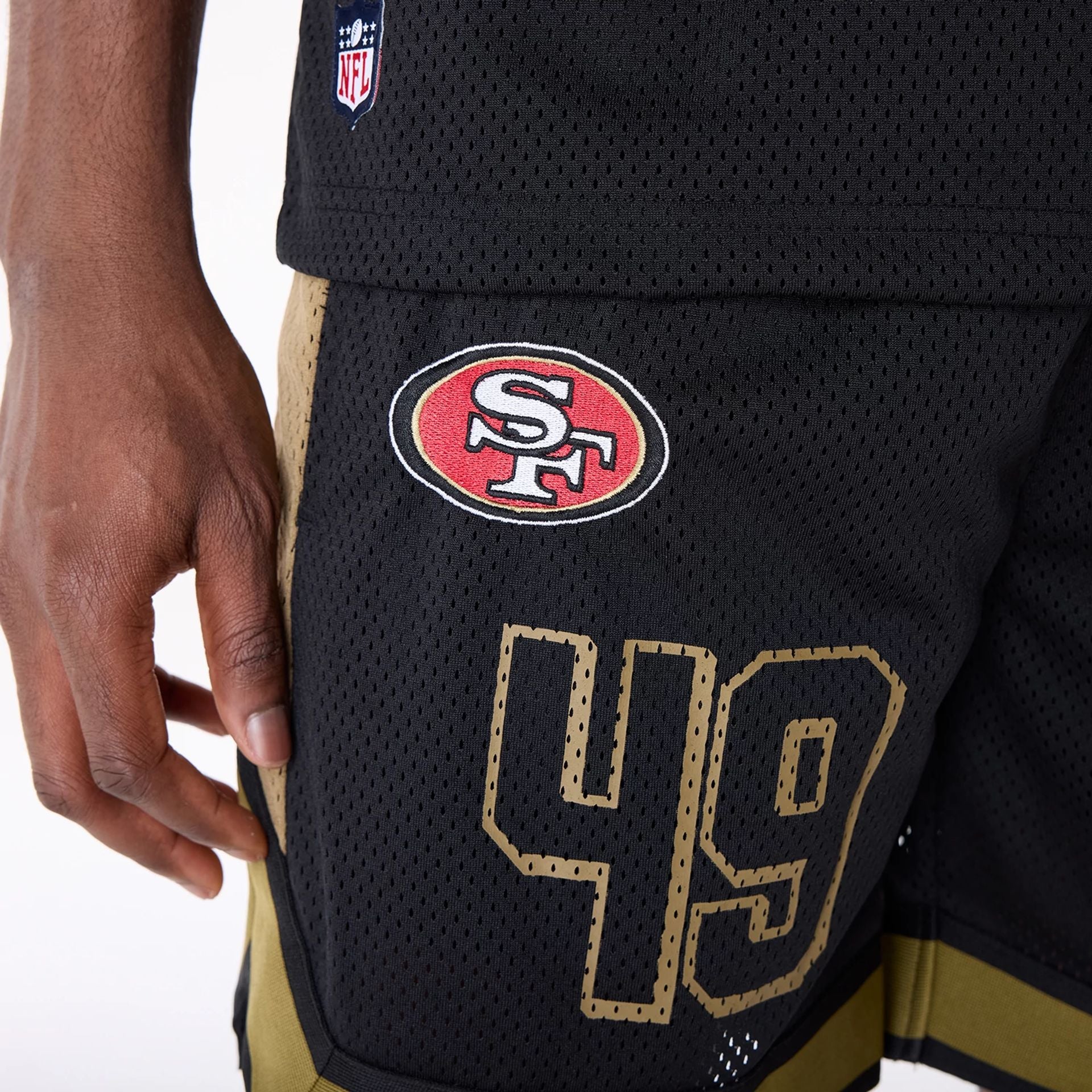 The Male model is wearing San Francisco 49ers NFL Mesh Black Shorts 7