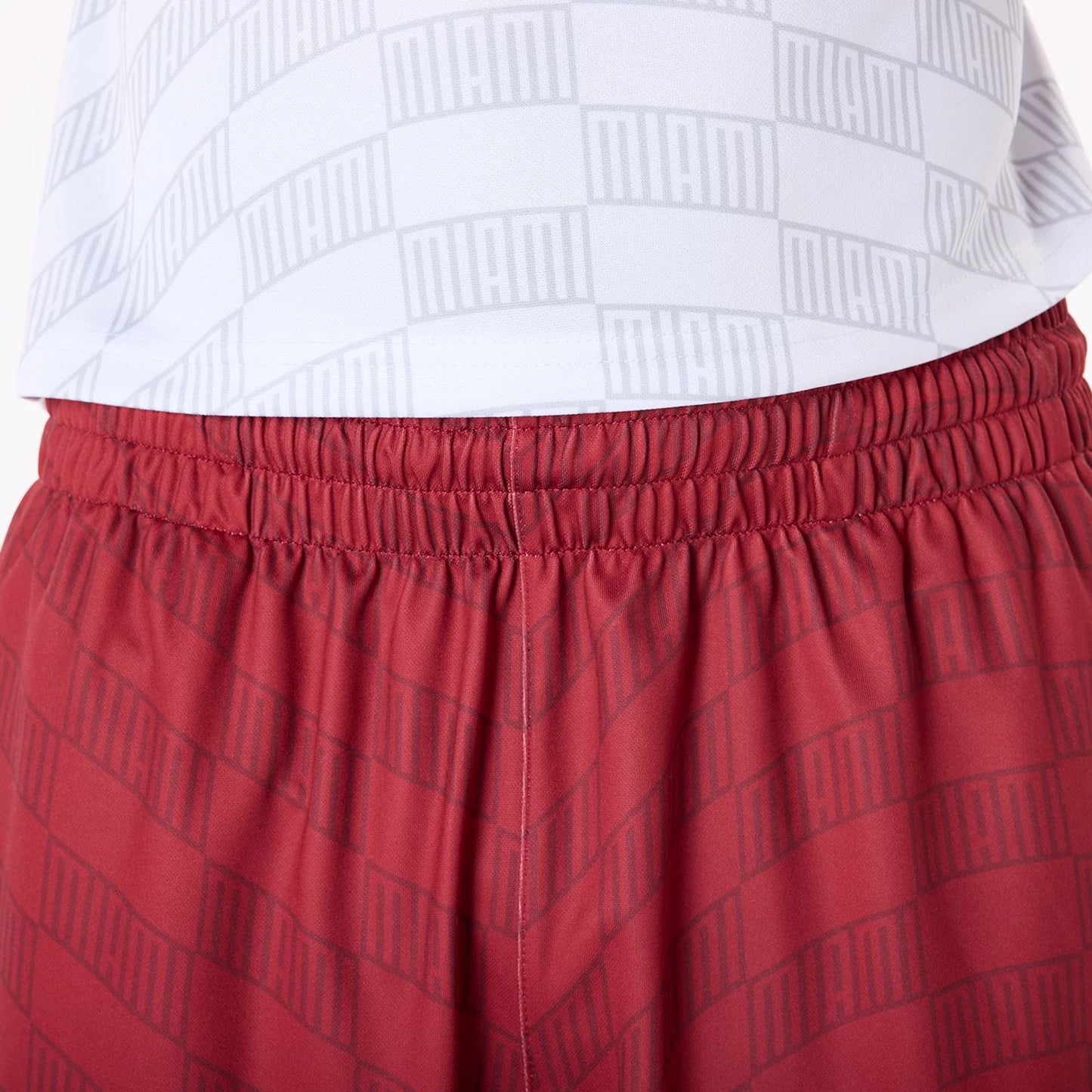 The Male model is wearing Miami Heat NBA All Over Print Graphic Dark Red Shorts 6