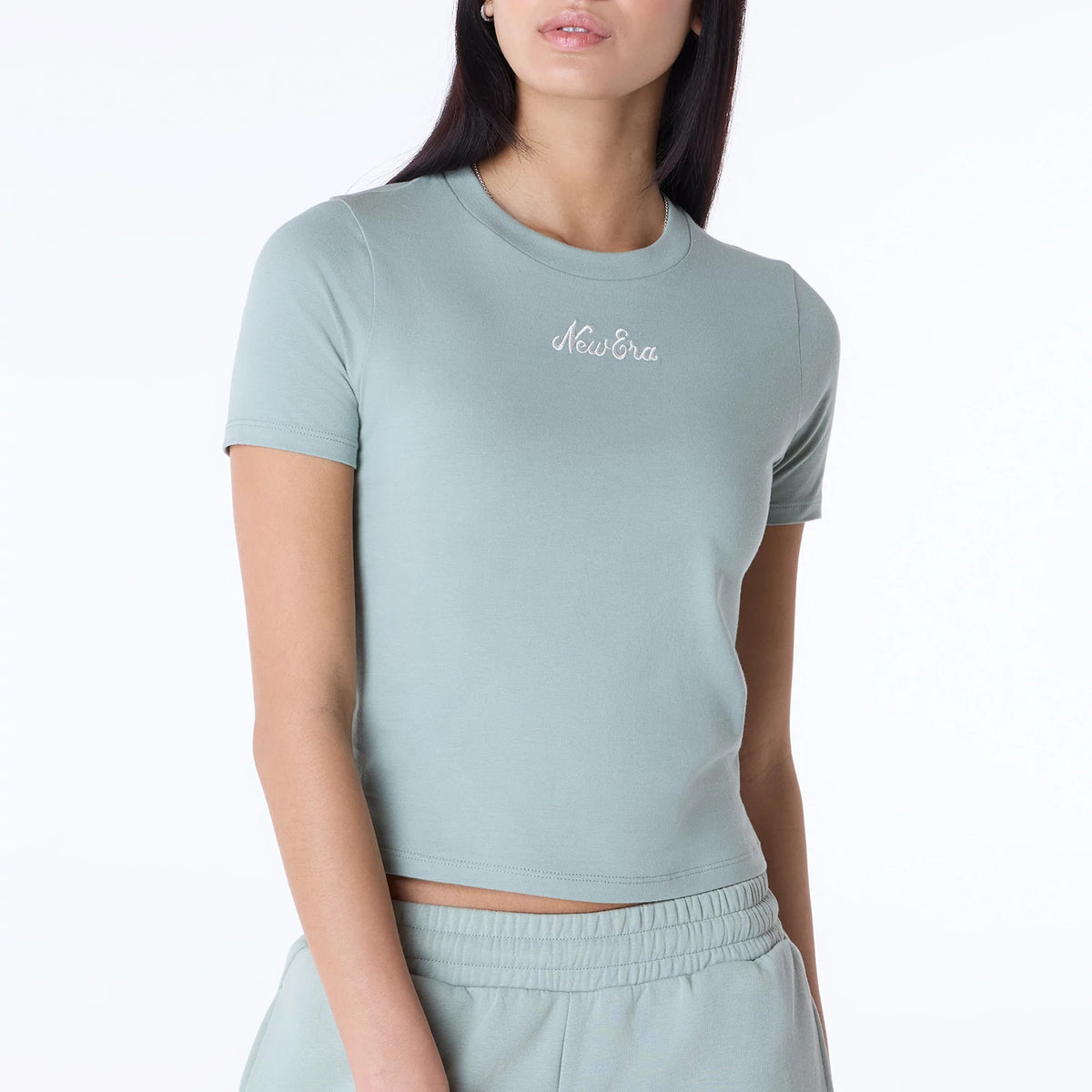 Womens New Era Slim Pastel Blue T-Shirt, front view showing a fitted pastel blue tee with short sleeves and a round neck, featuring an embroidered white New Era logo centred on the chest.