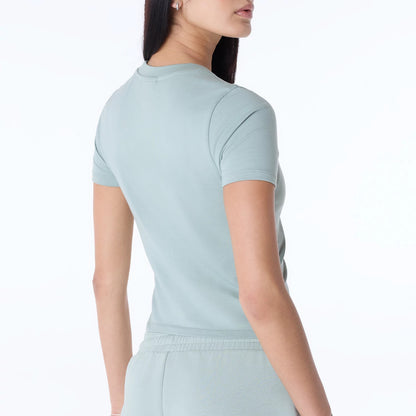 The Female model is wearing Womens New Era Slim Pastel Blue T-Shirt 6