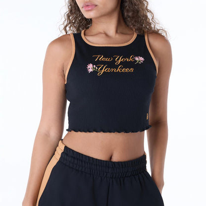 New Era New York Yankees Womens MLB Floral Black Vest, front view on a model showing New York Yankees script with floral embroidery across the chest and contrasting tan trim at the neckline and armholes.