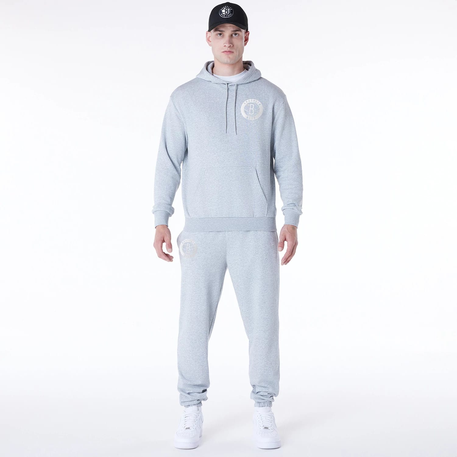 The Male model is wearing Brooklyn Nets NBA League Essential Grey Oversized Pullover Hoodie 3
