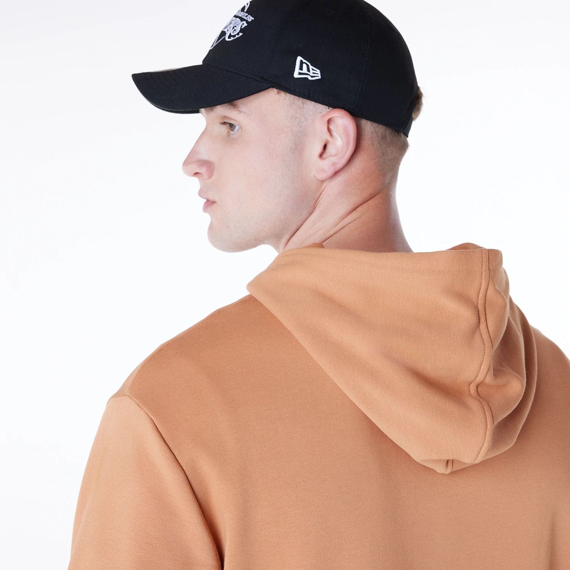 The Male model is wearing LA Lakers NBA League Essential Dark Beige Oversized Pullover Hoodie 5