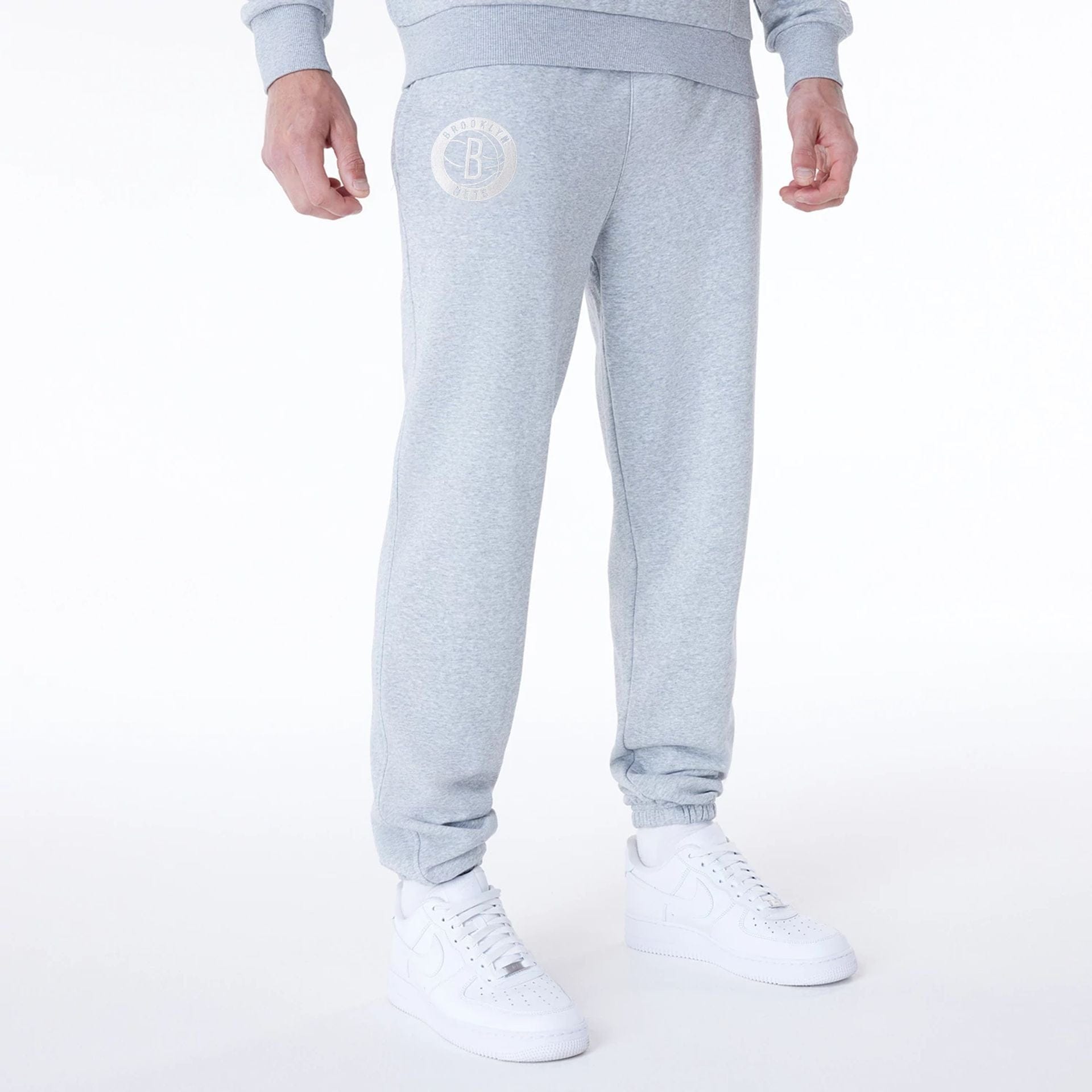 The Male model is wearing Brooklyn Nets NBA League Essential Grey Fleece Joggers 1
