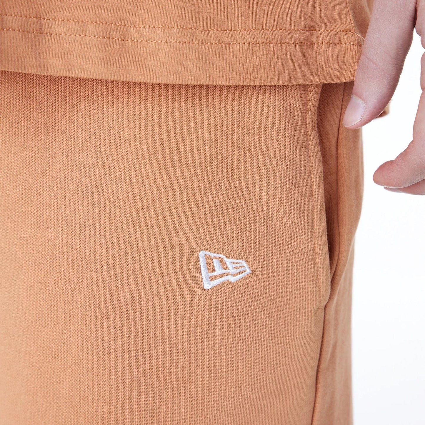 The Male model is wearing LA Lakers NBA League Essential Dark Beige Shorts 4