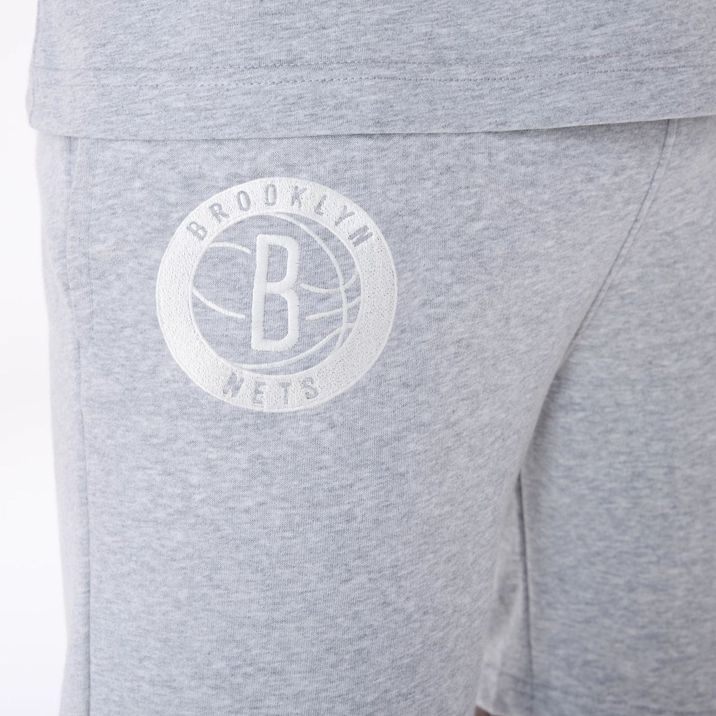 The Male model is wearing Brooklyn Nets NBA League Essential Grey Shorts 3
