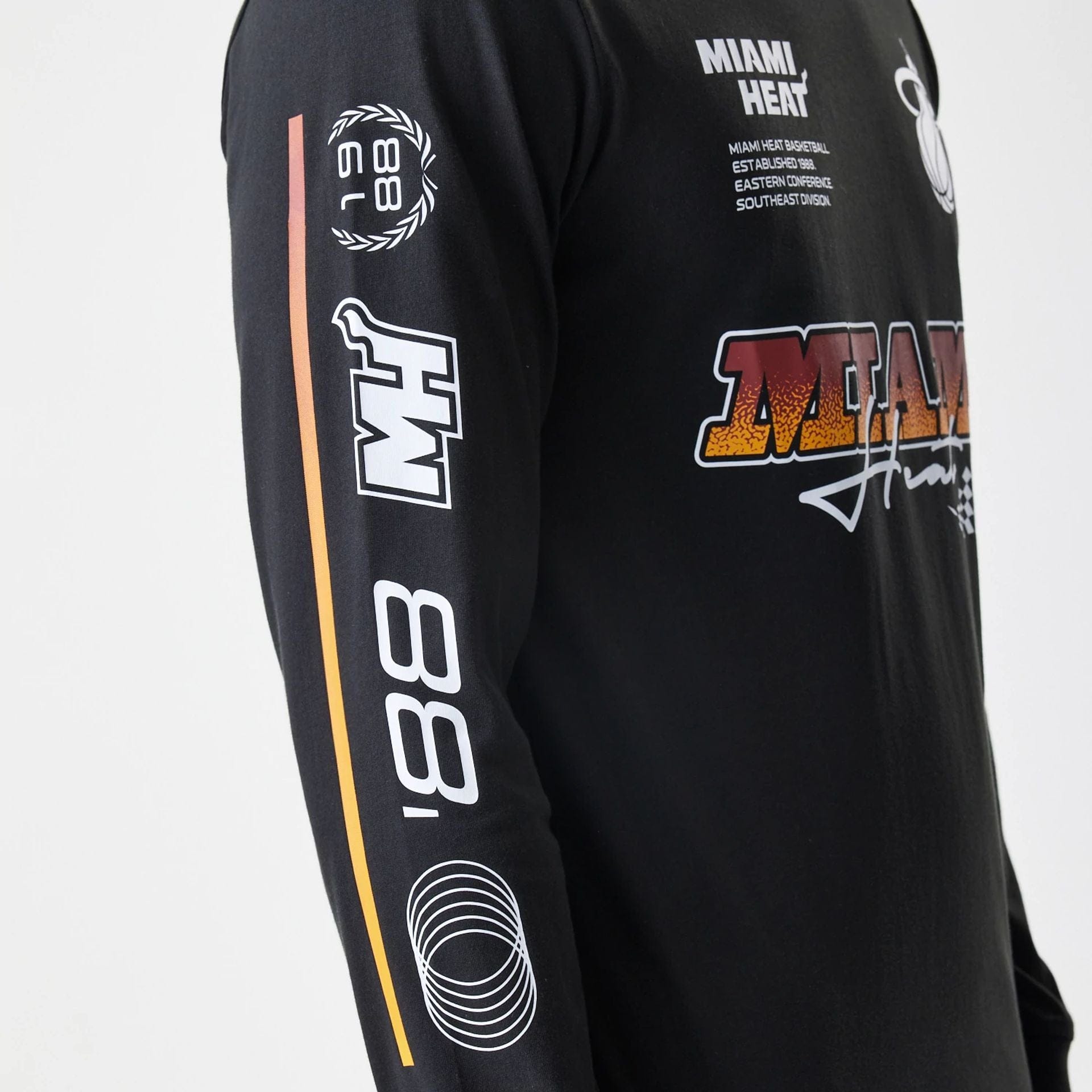 The Male model is wearing Miami Heat Modern Driver Black Long Sleeve T-Shirt 2