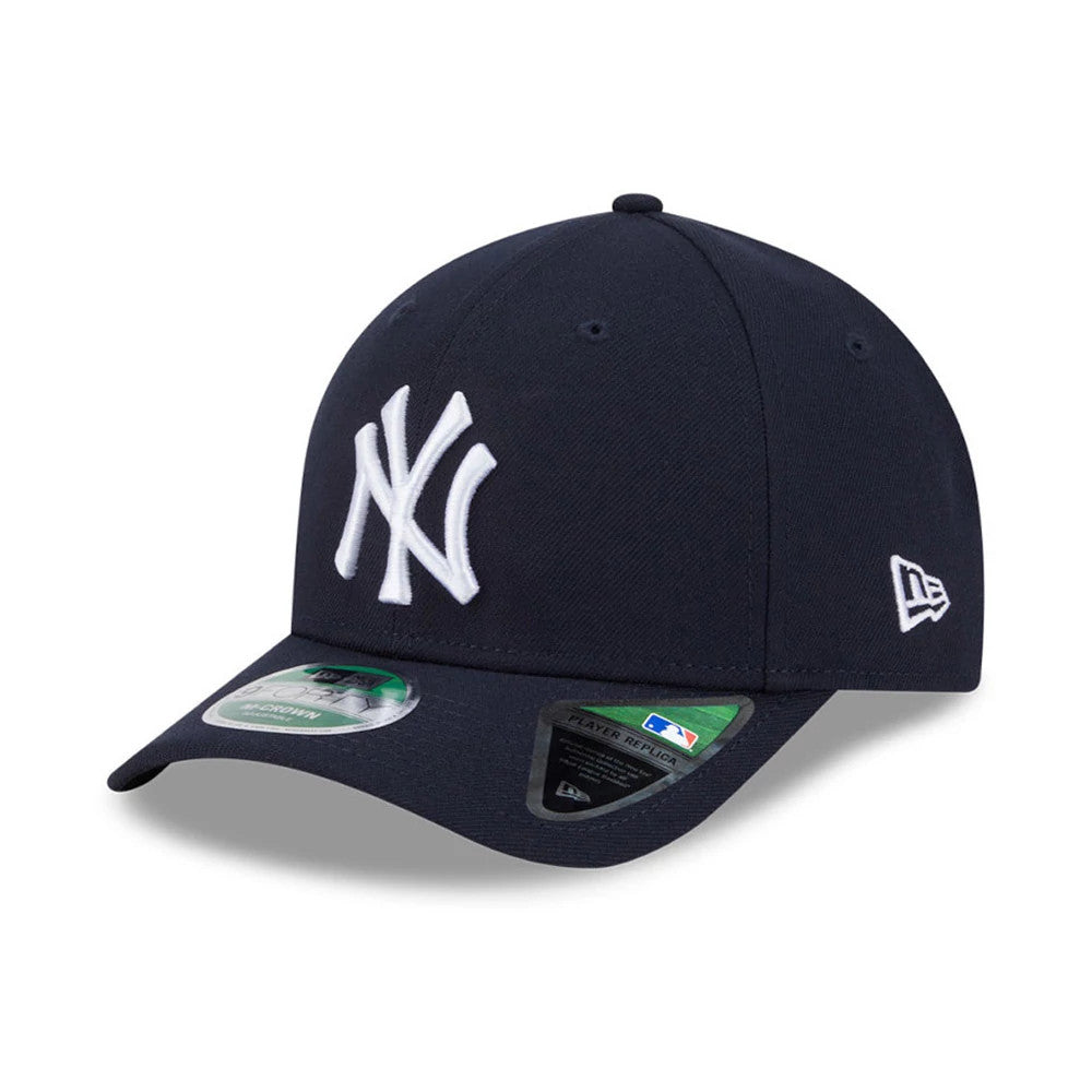 New York Yankees MLB Player Replica Navy New Era 9FORTY M-Crown Adjustable Cap, three-quarter view showing raised white NY logo on the front panel, navy visor with 9FORTY size sticker, and the embroidered New Era flag logo on the left side.