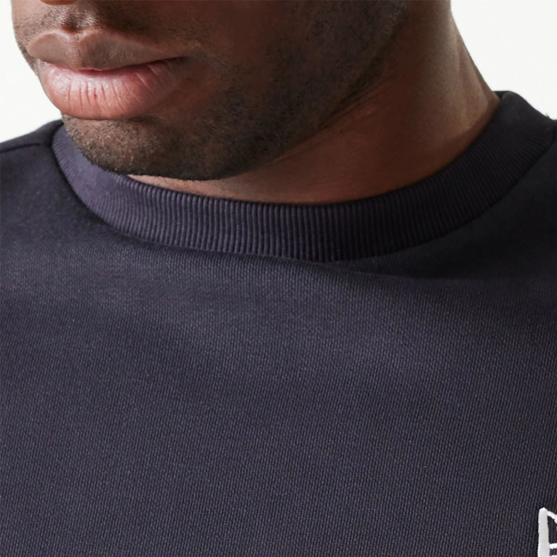 The Male model is wearing New Era Essential Brushed Fleece Navy Crewneck Sweater 7