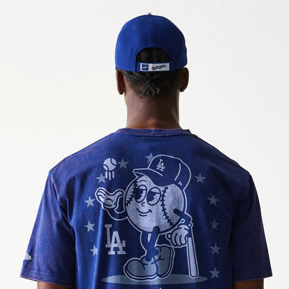 New Era LA Dodgers MLB Character Dark Blue T-Shirt, rear view showing a graphic of a baseball character wearing an LA cap with stars around, the LA logo below, and a blue cap with a debossed New Era logo worn by the model.
