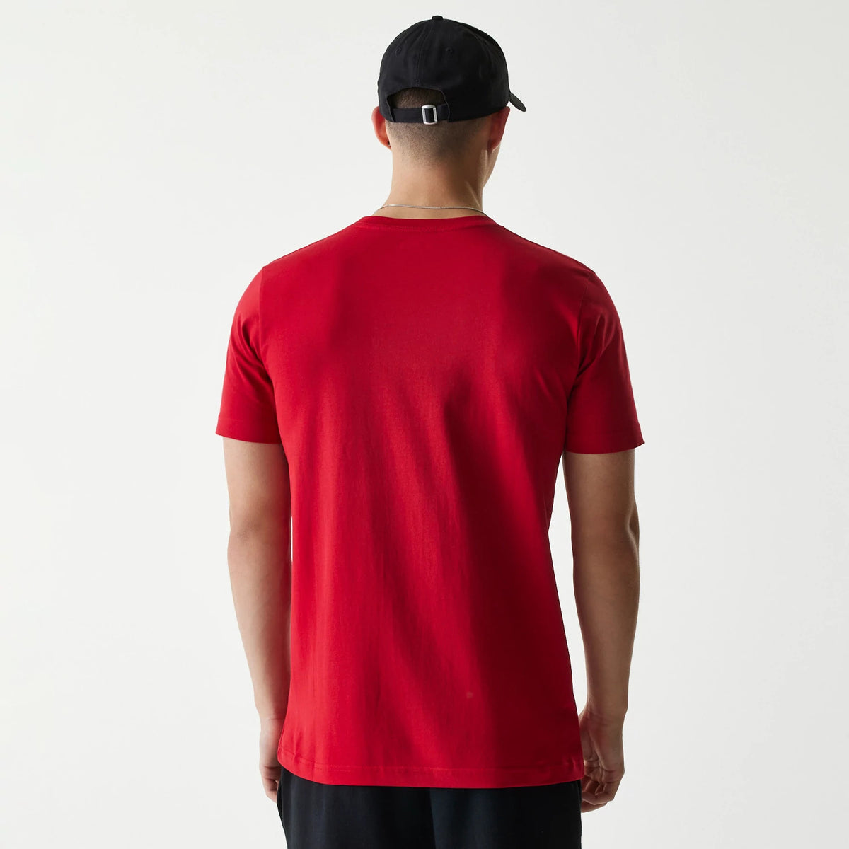 New Era Chicago White Sox MLB City Connect 2025 Red T-Shirt, rear view showing the plain red back, short sleeves, and round neckline, worn by a person also wearing a black cap with an adjustable strap at the back.