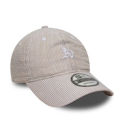 Athletics MLB Seersucker Light Beige New Era 9TWENTY Adjustable Cap, three-quarter view showing a raised white A's embroidered logo on the front panel, with a curved visor featuring a 9TWENTY size sticker.