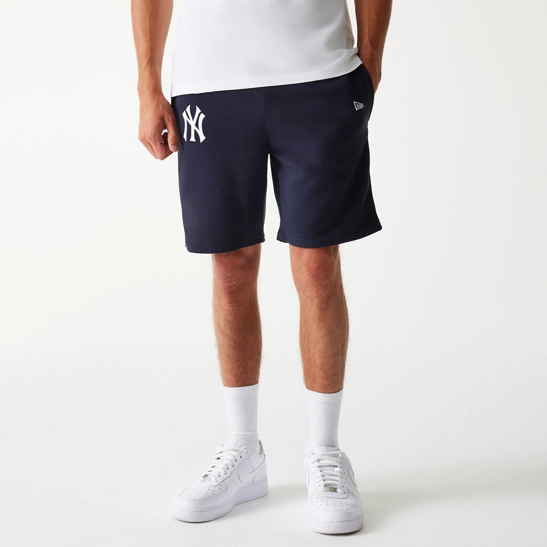 The Male model is wearing New York Yankees MLB League Essential Navy Shorts 1