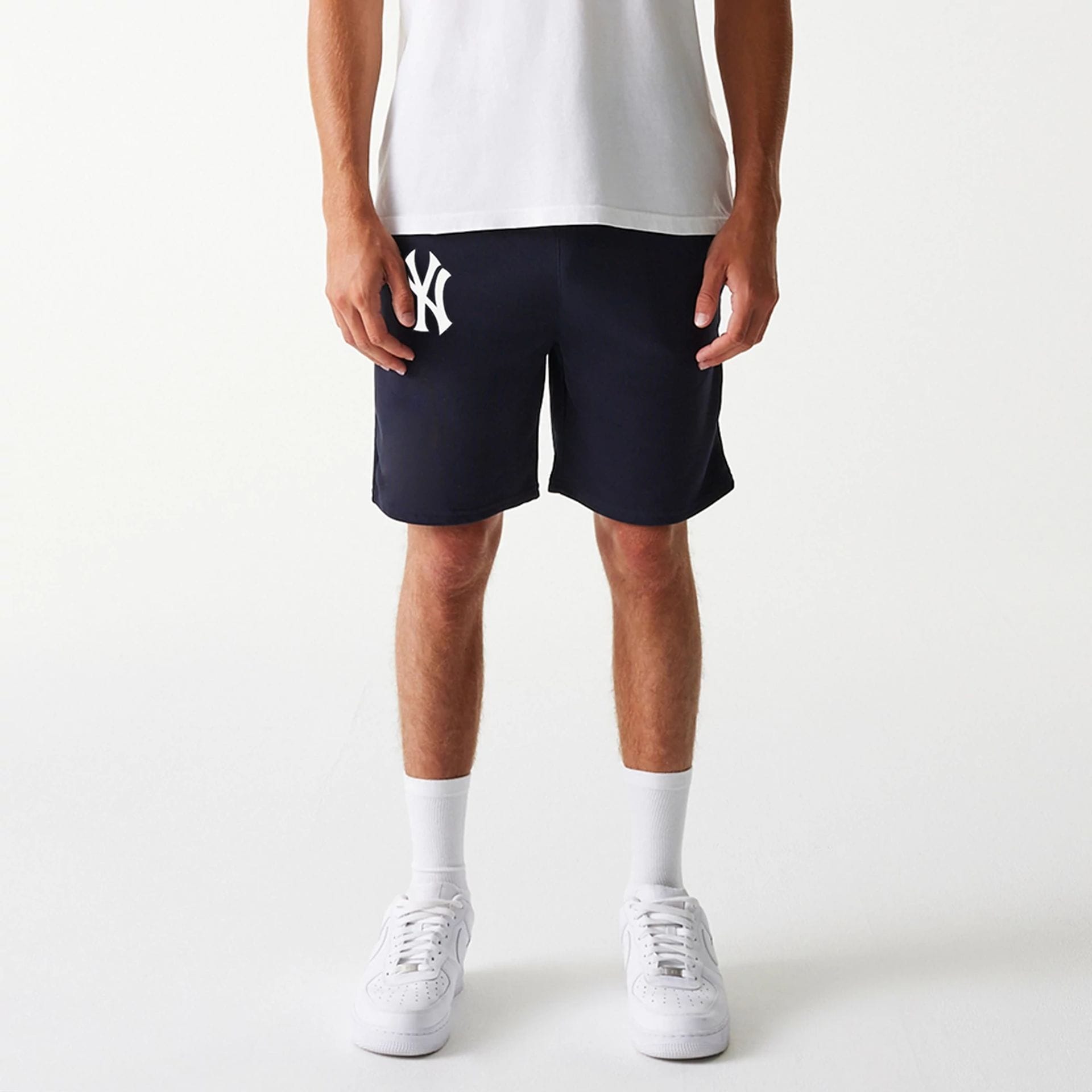 The Male model is wearing New York Yankees MLB League Essential Navy Shorts 8