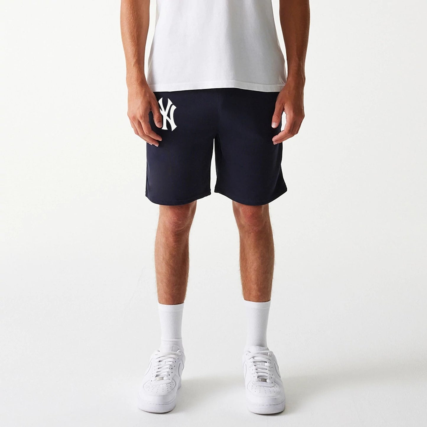 The Male model is wearing New York Yankees MLB League Essential Navy Shorts 8
