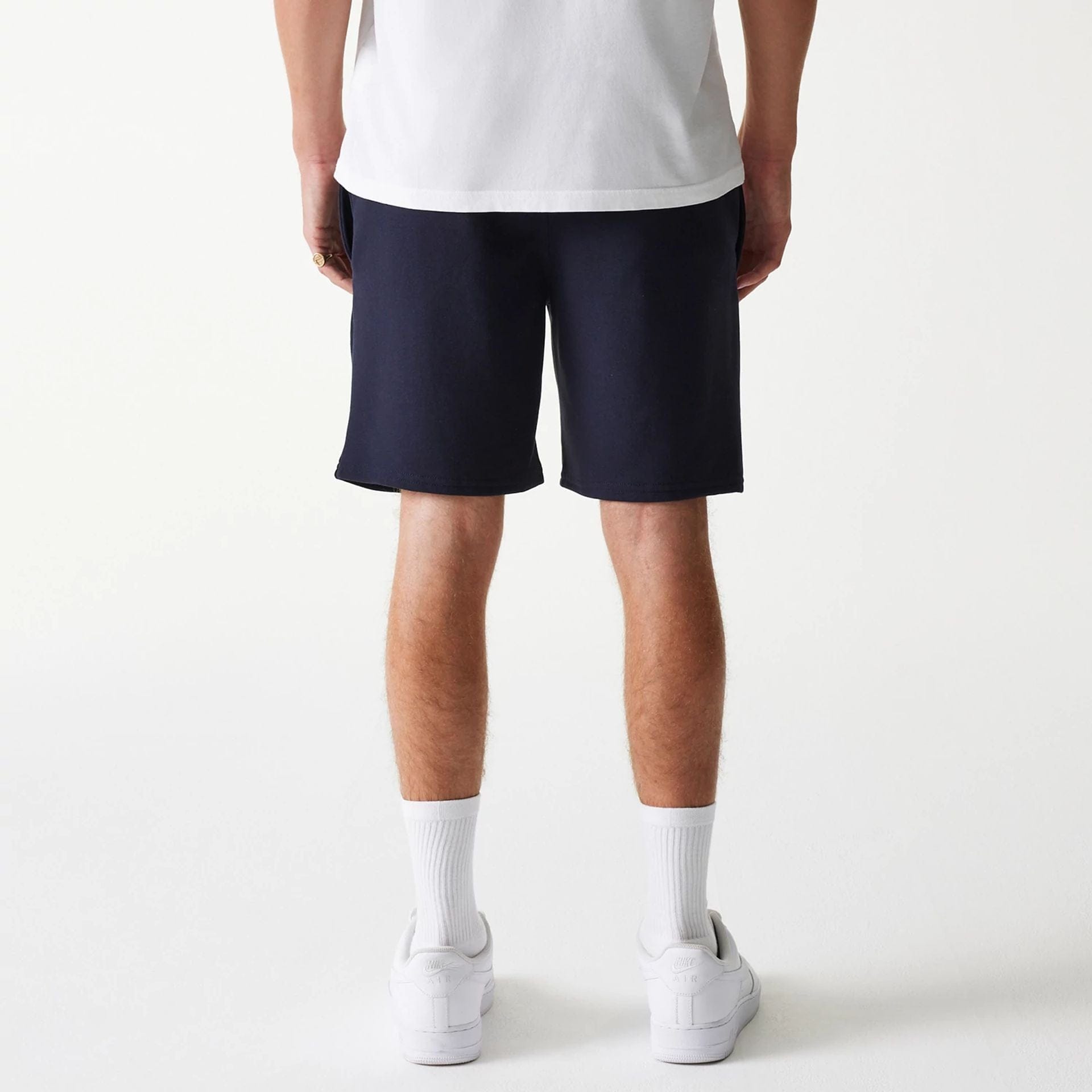 The Male model is wearing New York Yankees MLB League Essential Navy Shorts 2