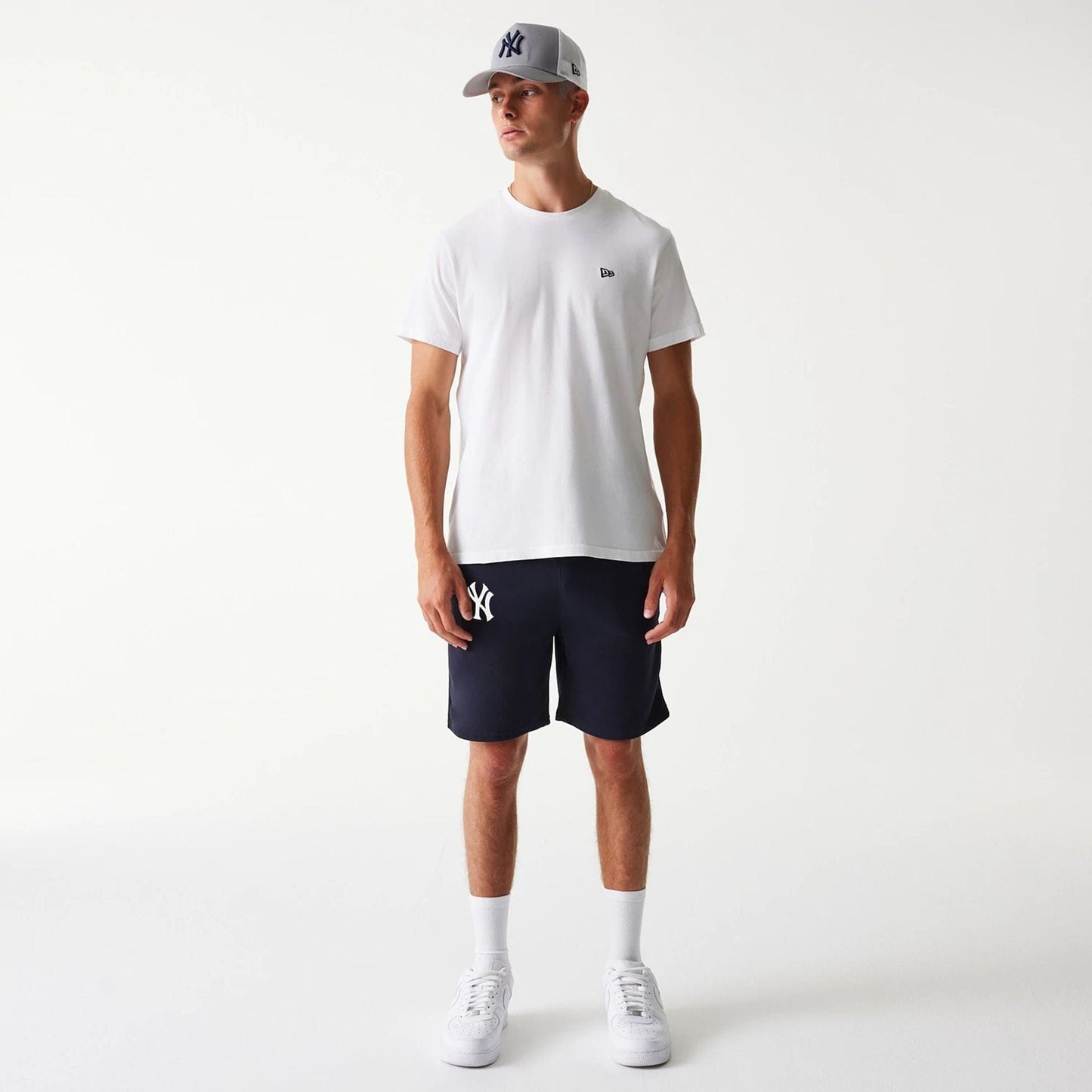 The Male model is wearing New York Yankees MLB League Essential Navy Shorts 7