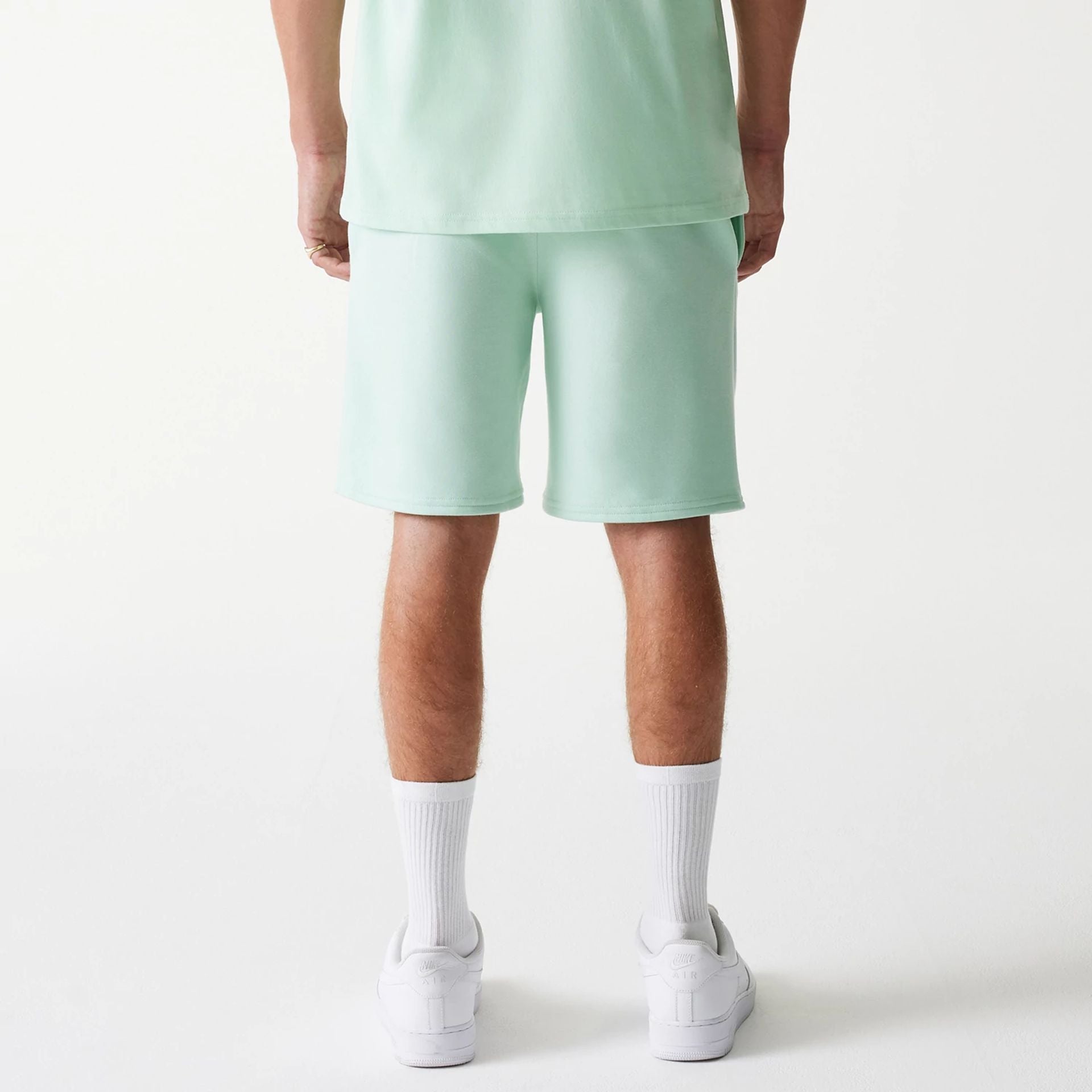 The Male model is wearing LA Dodgers MLB League Essential Pastel Green Shorts 2