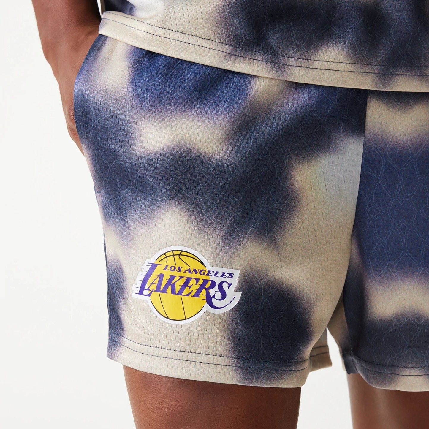 The Male model is wearing LA Lakers NBA All Over Print Cream Shorts 4