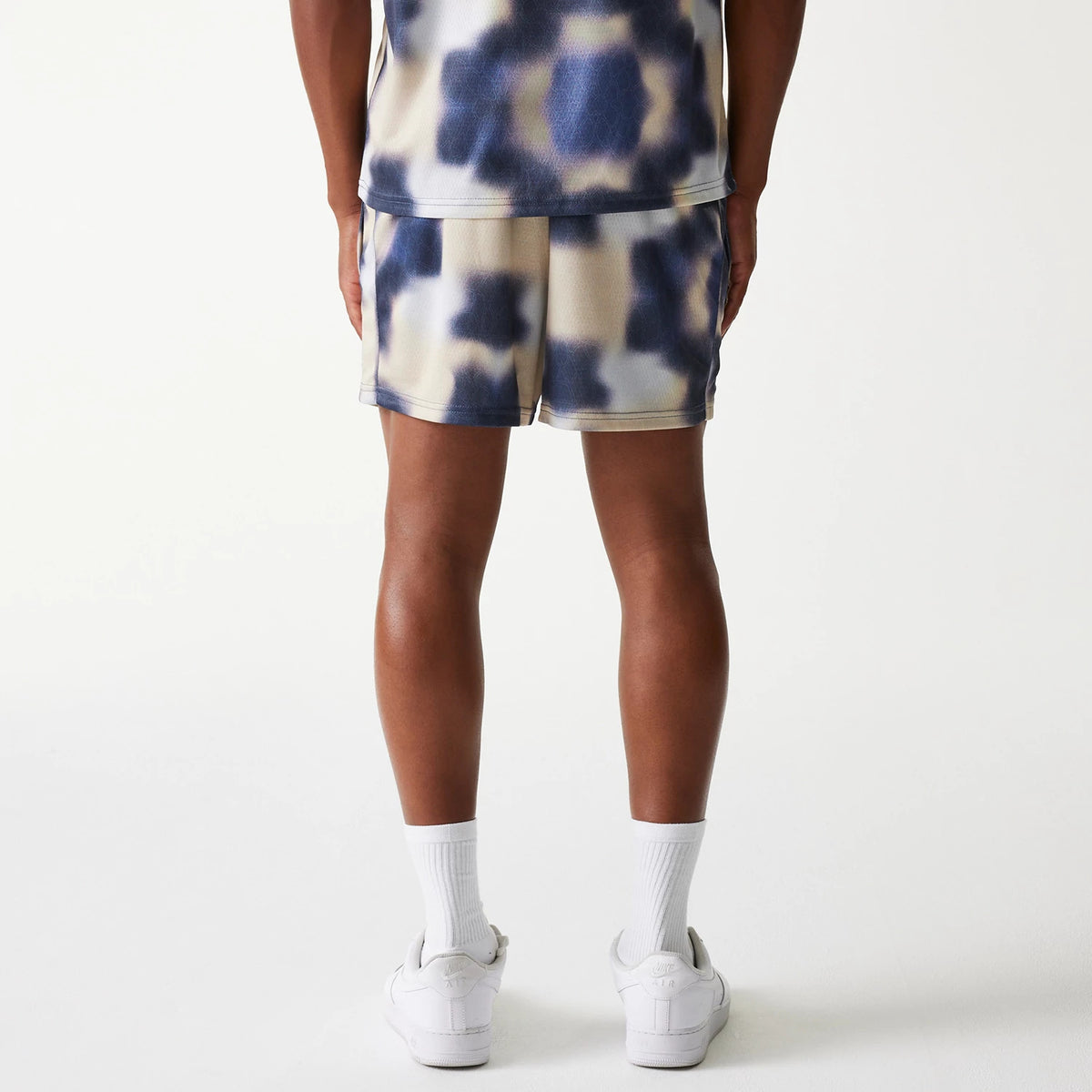 New Era LA Lakers NBA All Over Print Cream Shorts, rear view showing cream shorts with a blue and cream all-over print design, ending above the knees with an elastic waistband and loose fit.