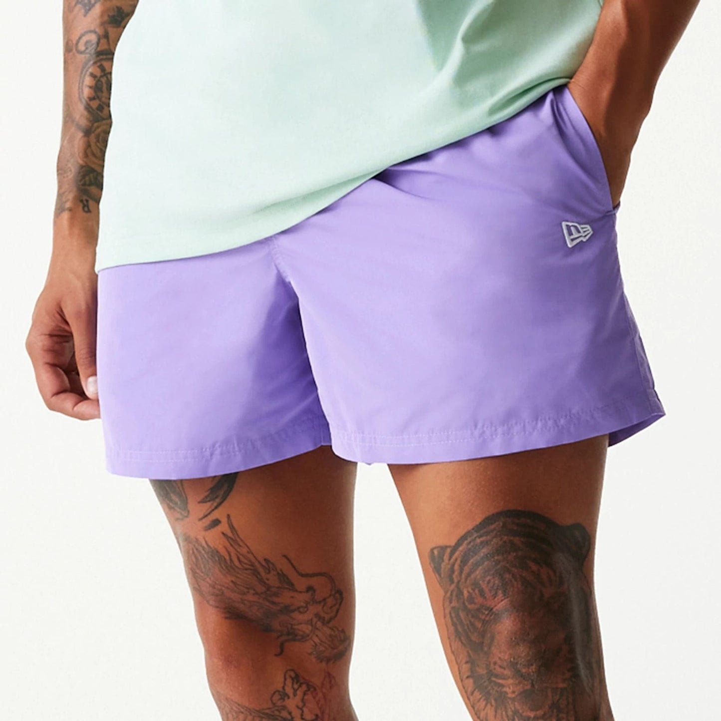 The Male model is wearing New Era Purple Swim Shorts 3