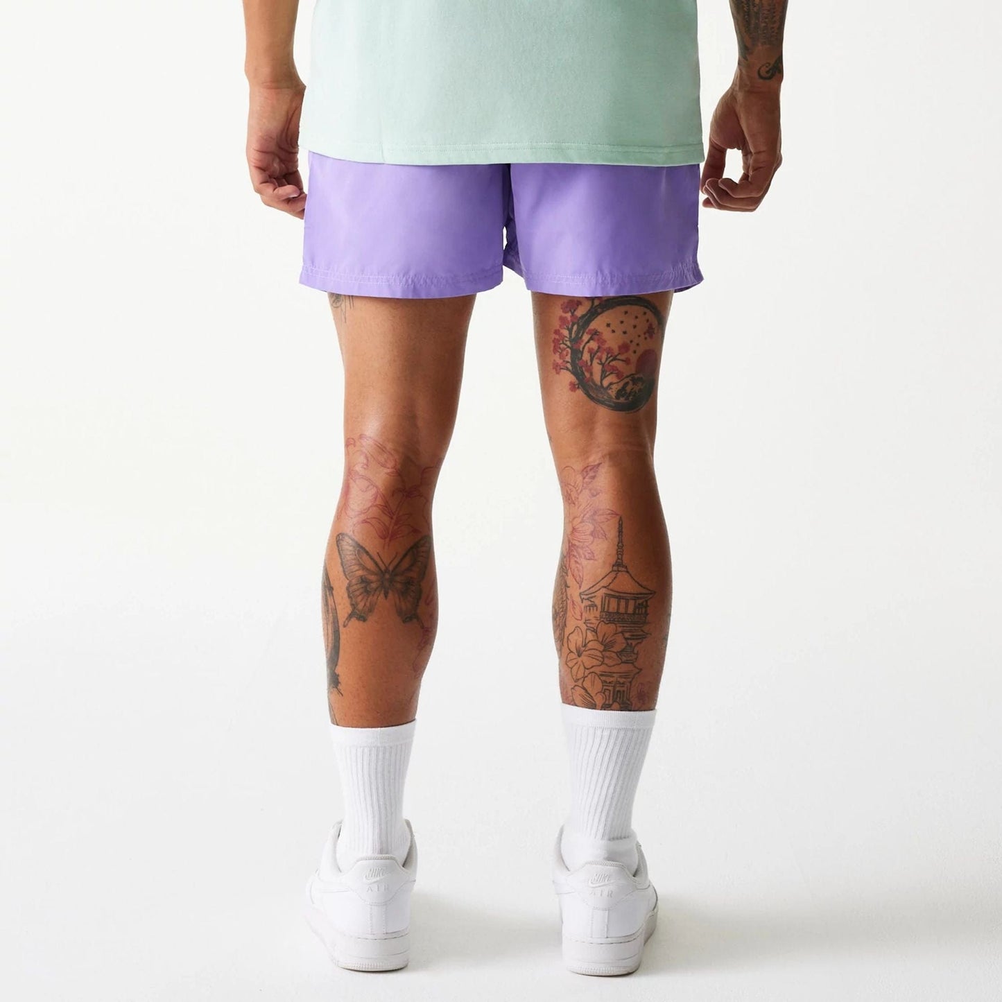 The Male model is wearing New Era Purple Swim Shorts 2