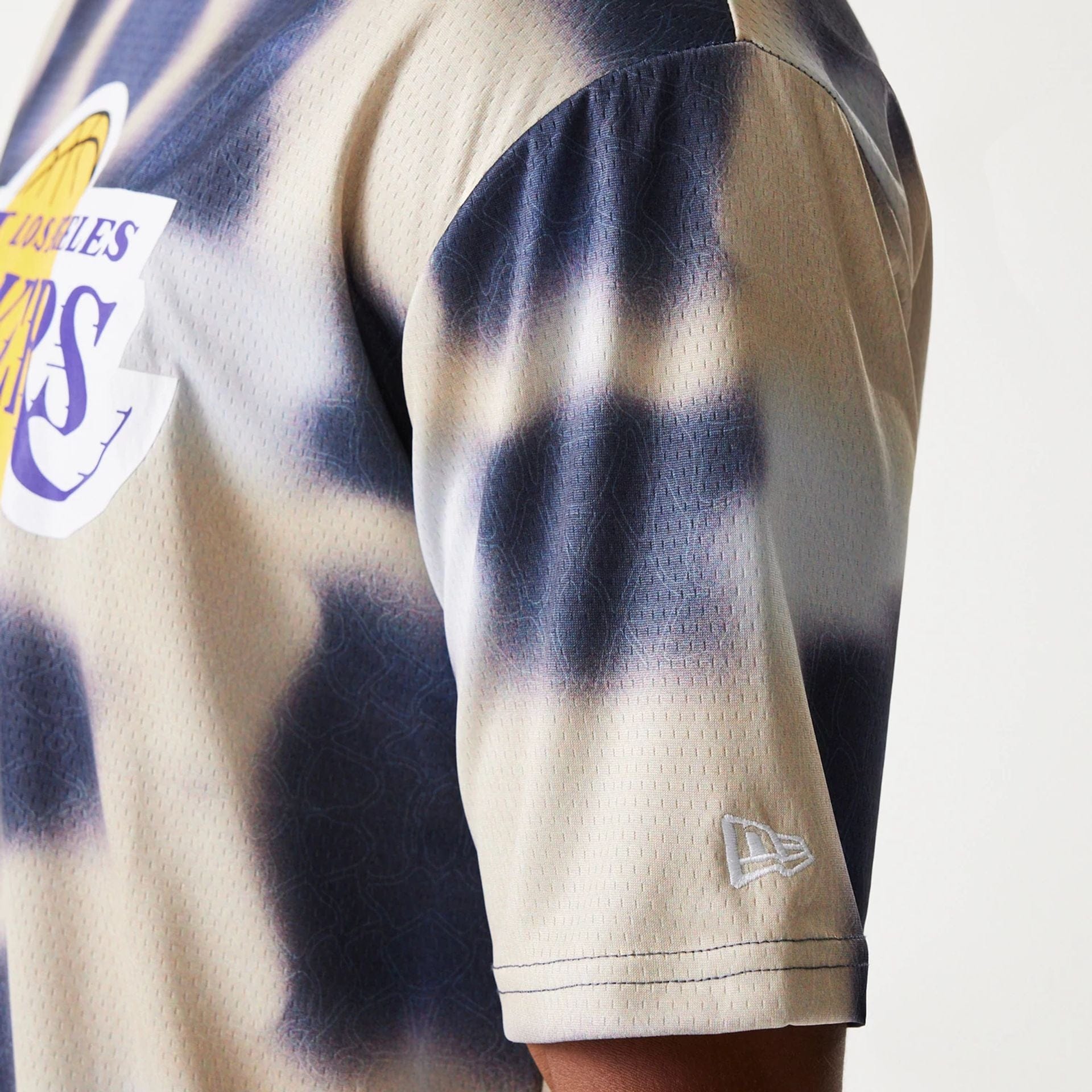 The Male model is wearing LA Lakers NBA All Over Print Cream Oversized T-Shirt 5