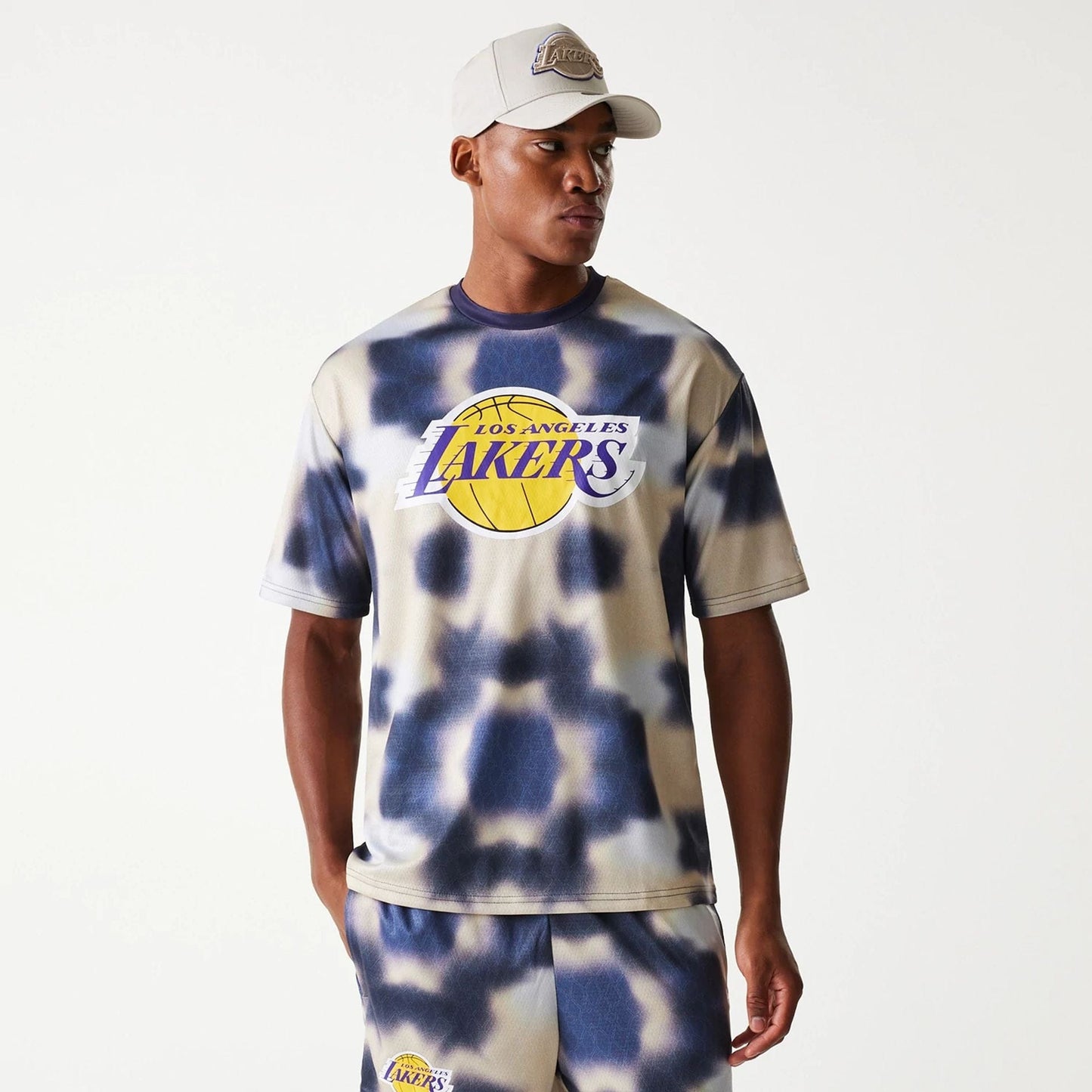 The Male model is wearing LA Lakers NBA All Over Print Cream Oversized T-Shirt 1