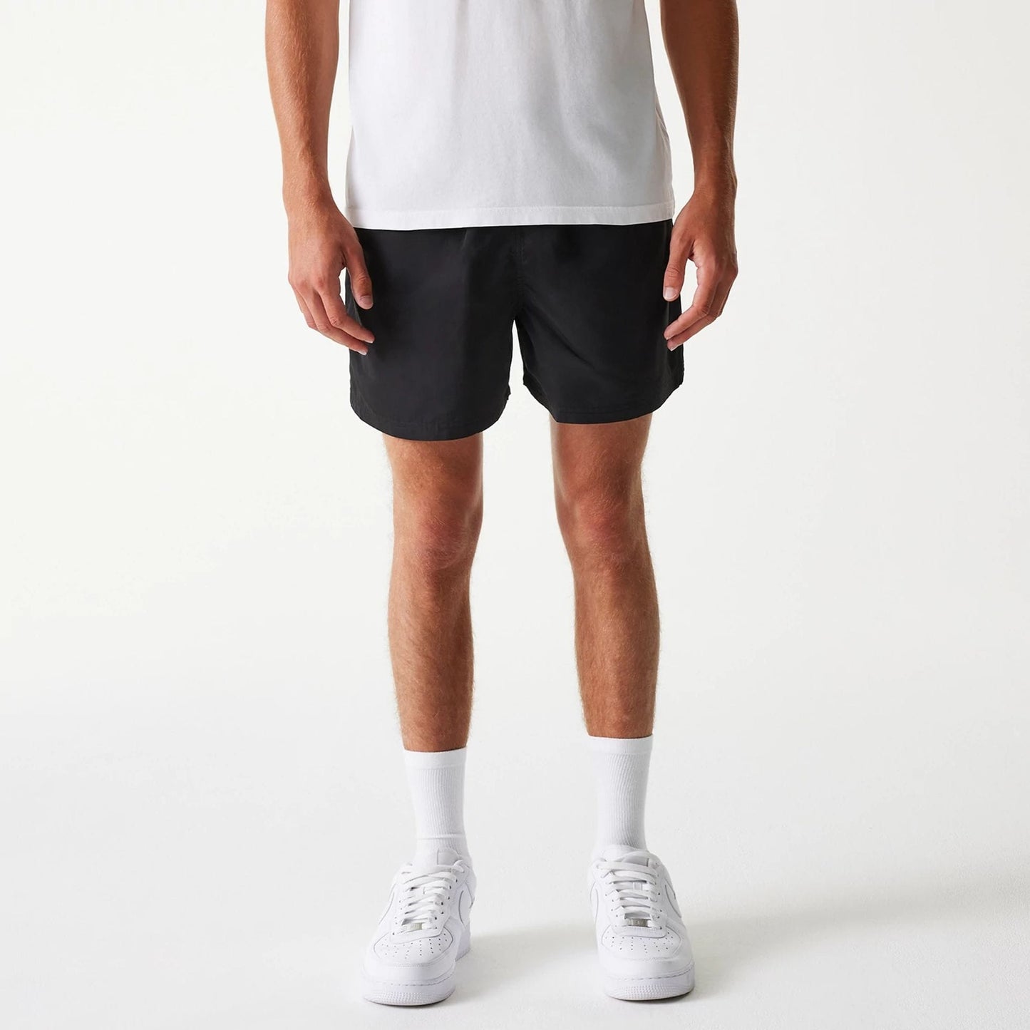 The Male model is wearing New Era Black Swim Shorts 1