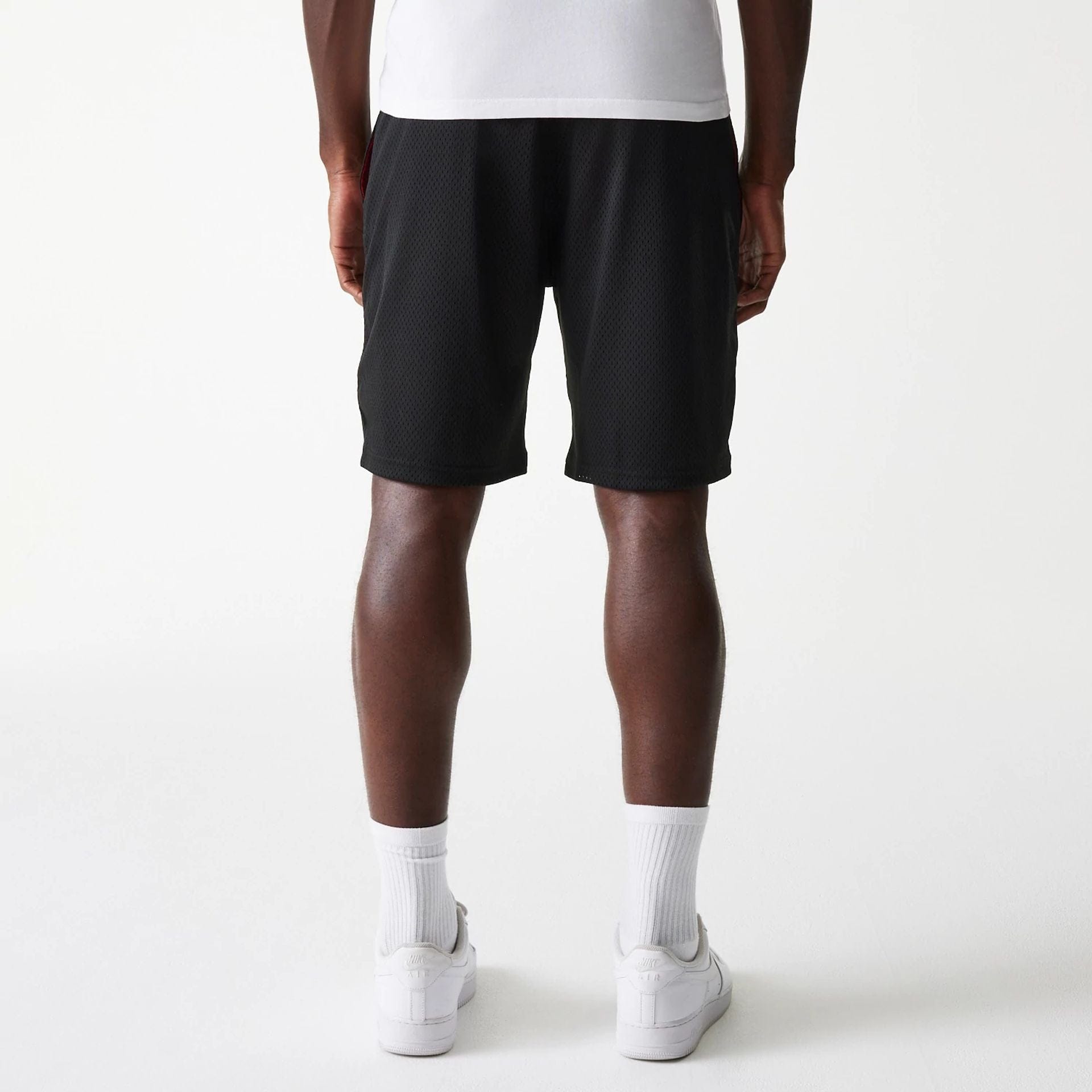 The Male model is wearing New Era Black Mesh Shorts 2