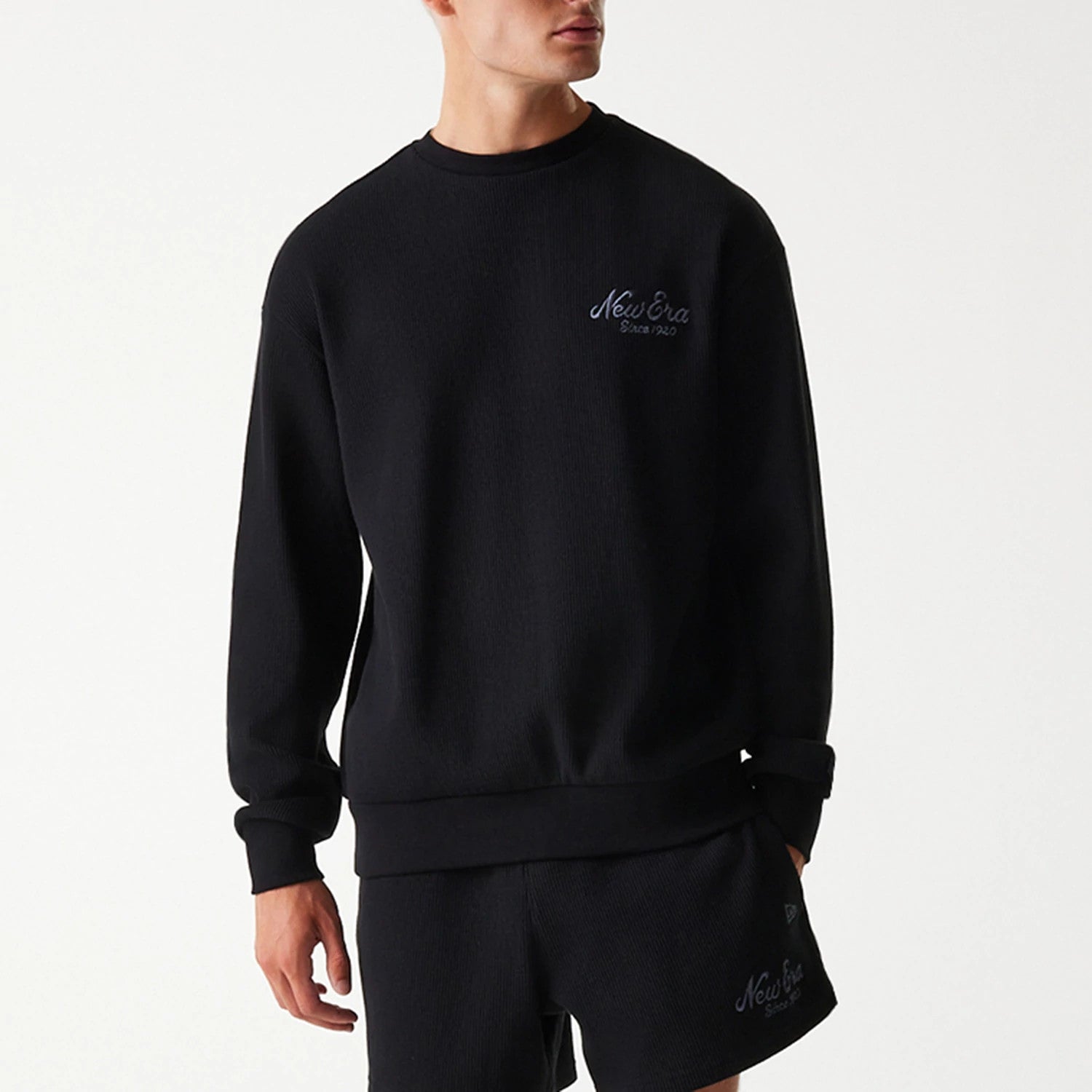 The Male model is wearing New Era Waffle Black Oversized Crew Neck Sweater 3