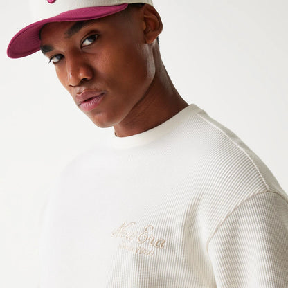 The Male model is wearing New Era Waffle Open White Oversized Crew Neck Sweater 6