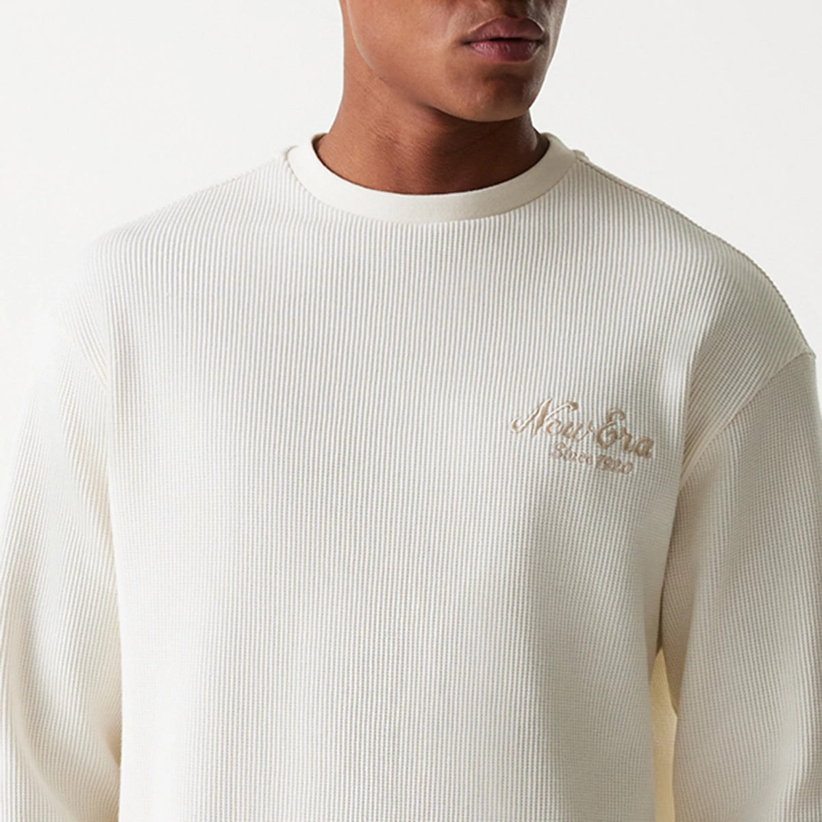 The Male model is wearing New Era Waffle Open White Oversized Crew Neck Sweater 3