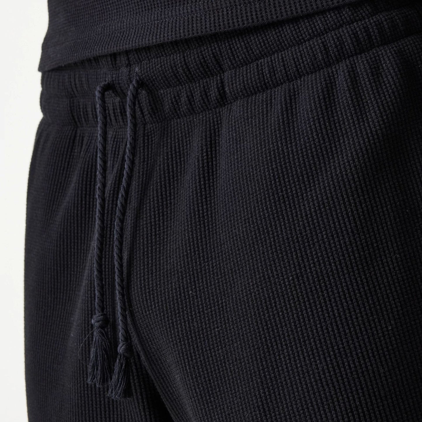The Male model is wearing New Era Waffle Black Shorts 8