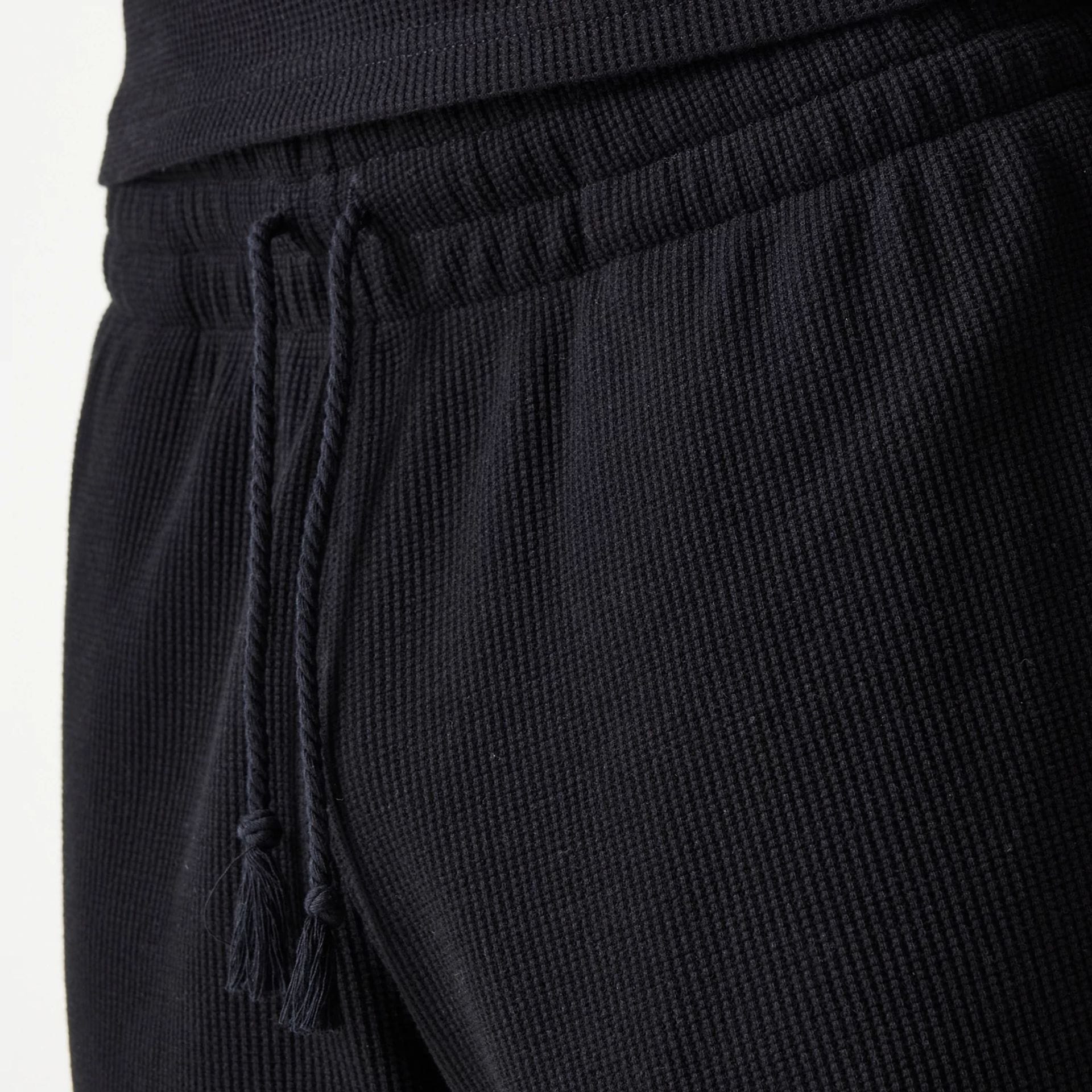 The Male model is wearing New Era Waffle Black Shorts 8