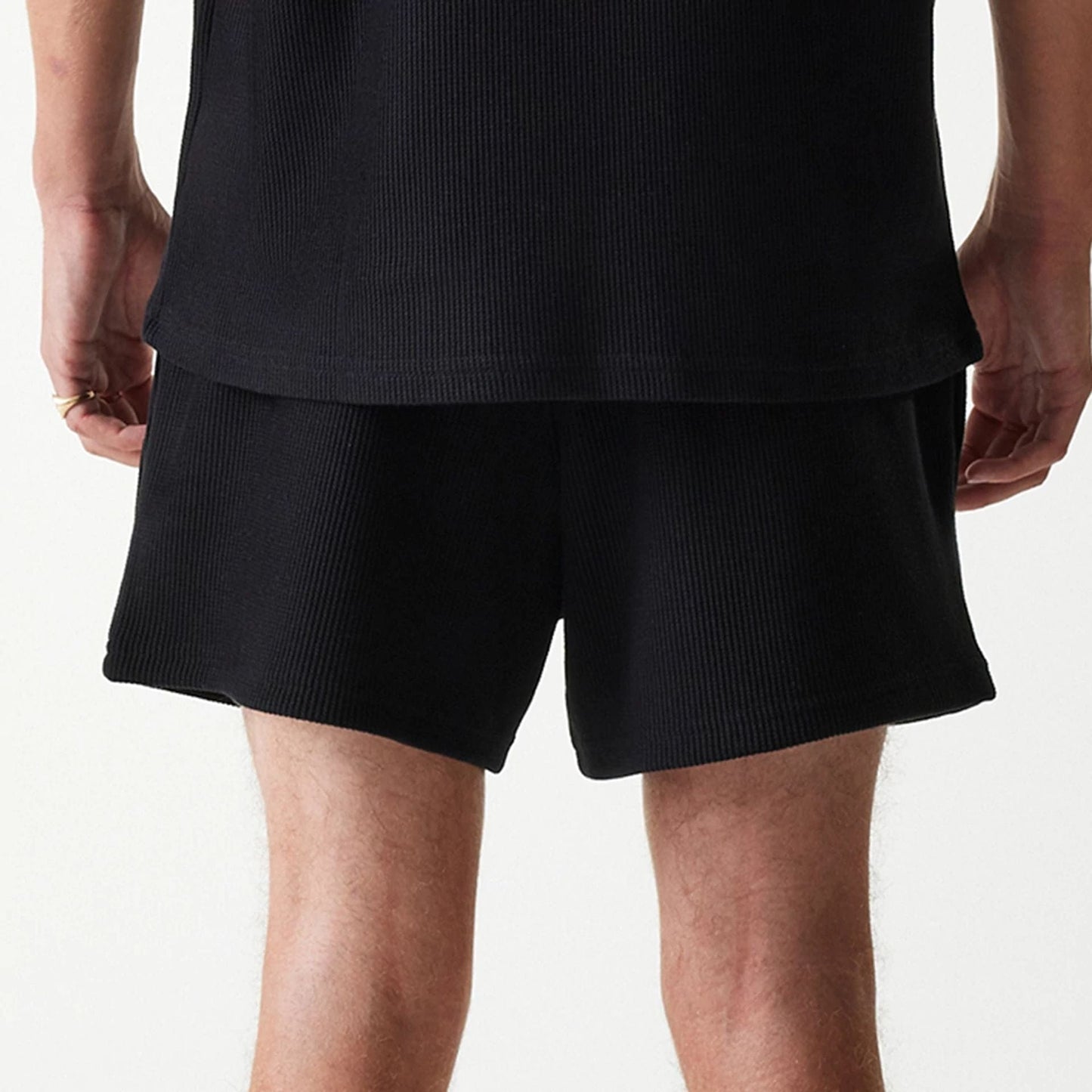 The Male model is wearing New Era Waffle Black Shorts 5