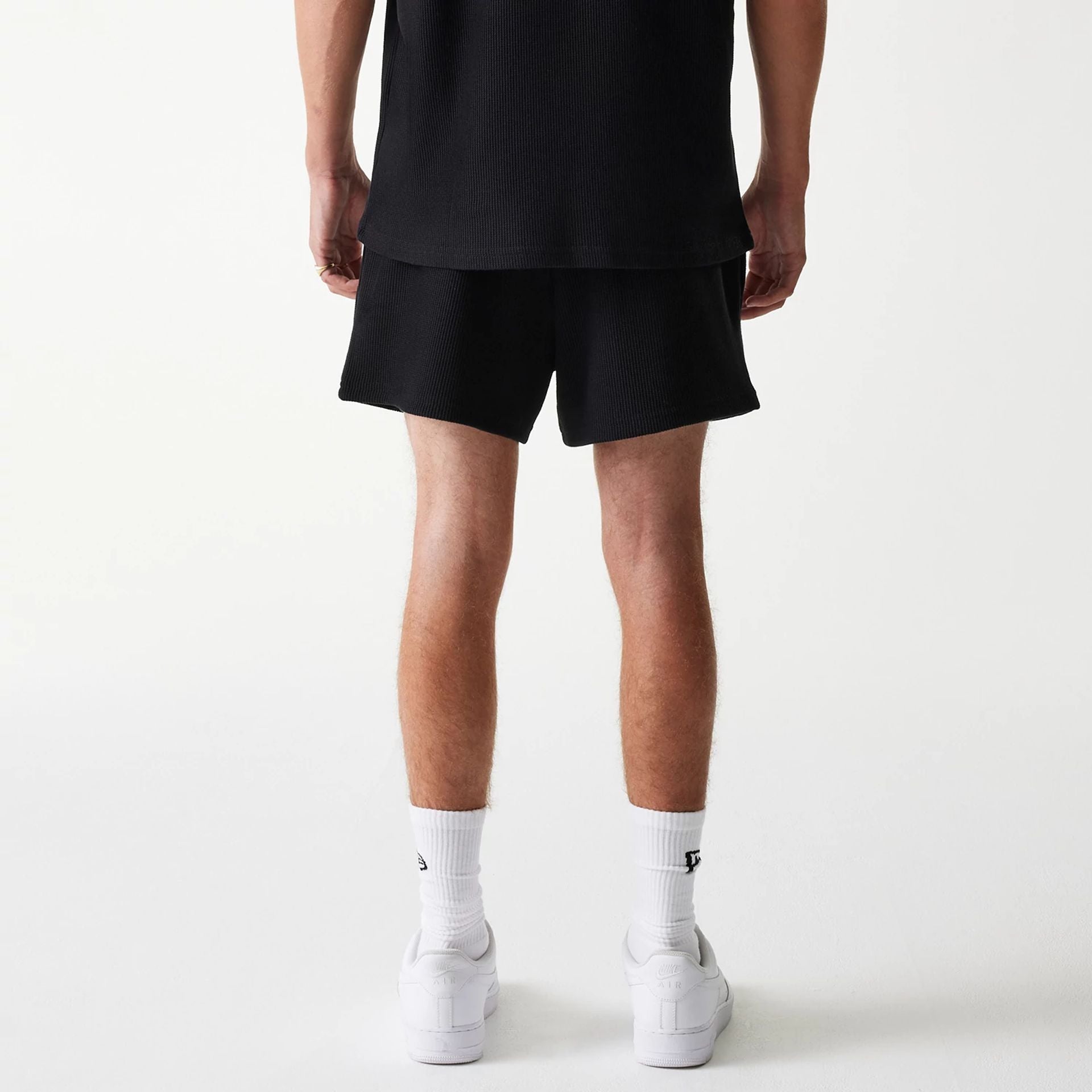 The Male model is wearing New Era Waffle Black Shorts 2